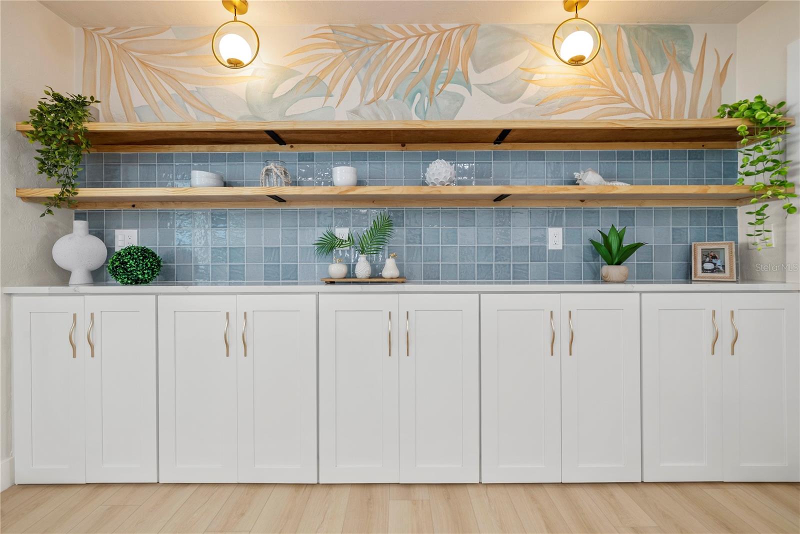 Close up detail of the back wall of the kitchen with floating shelves and additional storage