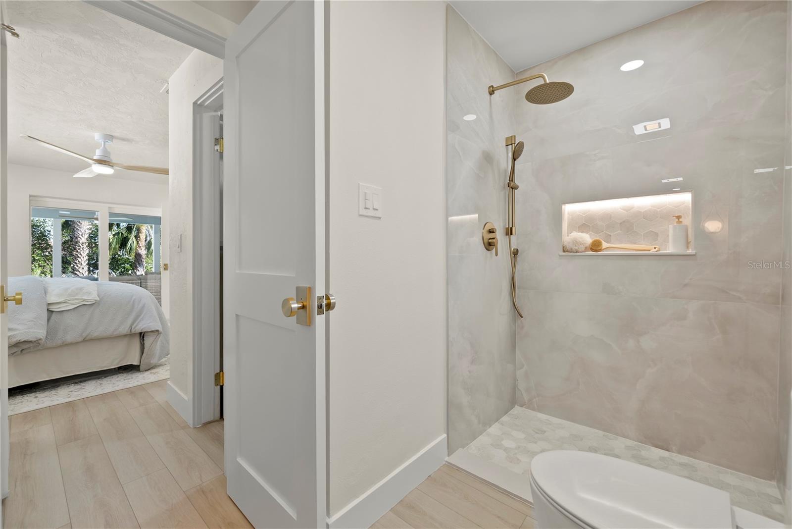 Primary en suite bathroom with detail of the walk in shower