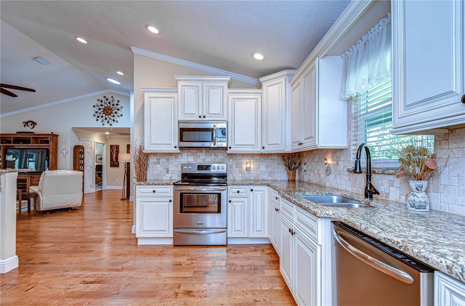 Cabinets accented with molding and tiled back splash make this kitchen a pinnacle of luxury!