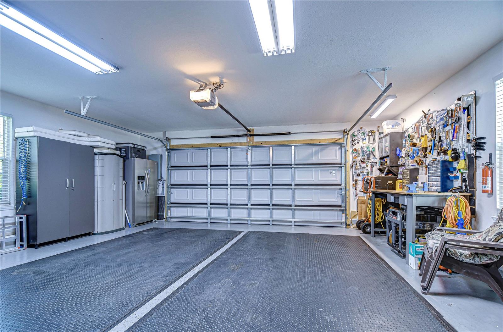 Transform your projects in this pristine double garage, equipped with ample storage and workspace