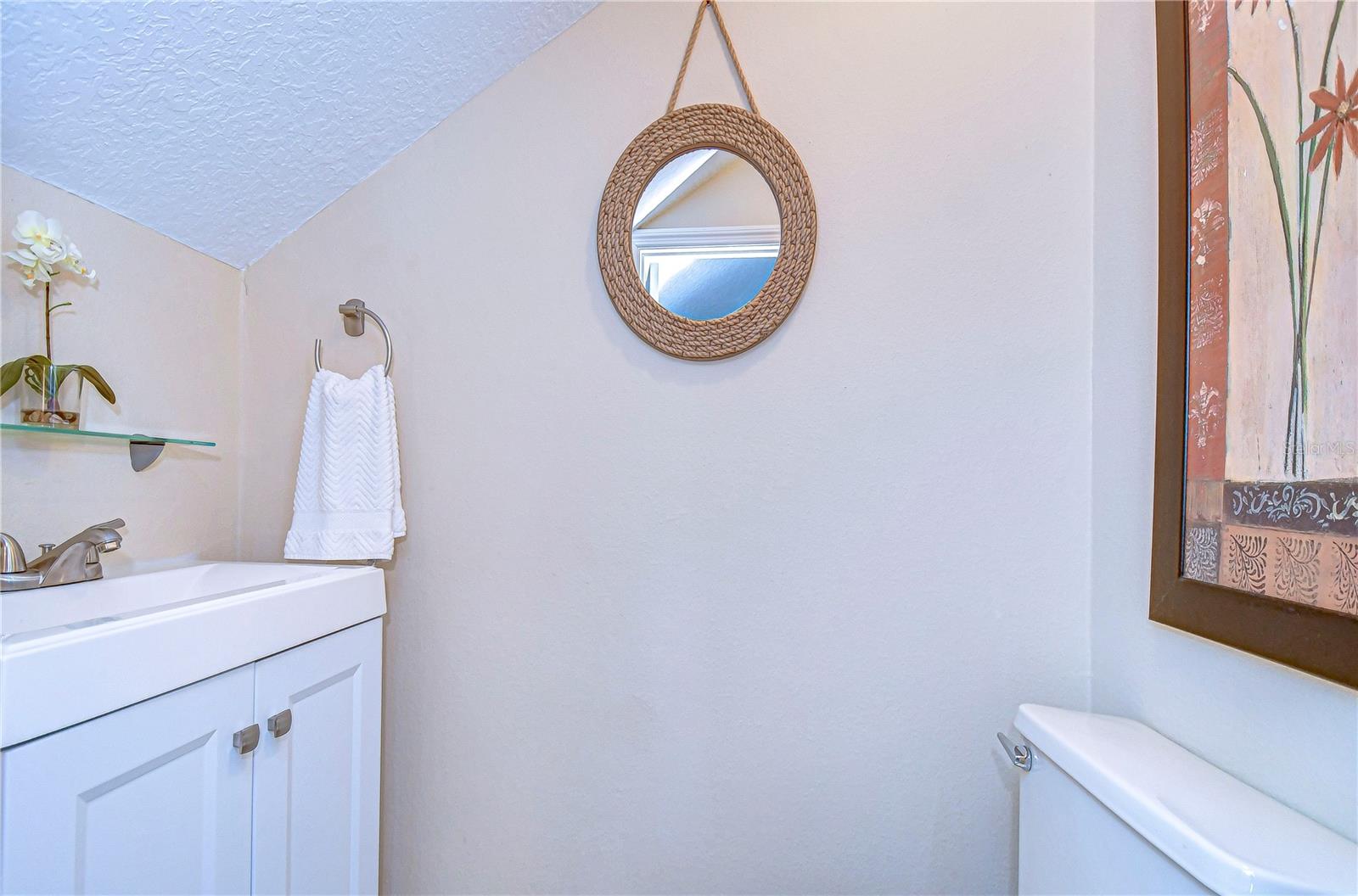 This cozy half-bath greets guests with a touch of elegance.