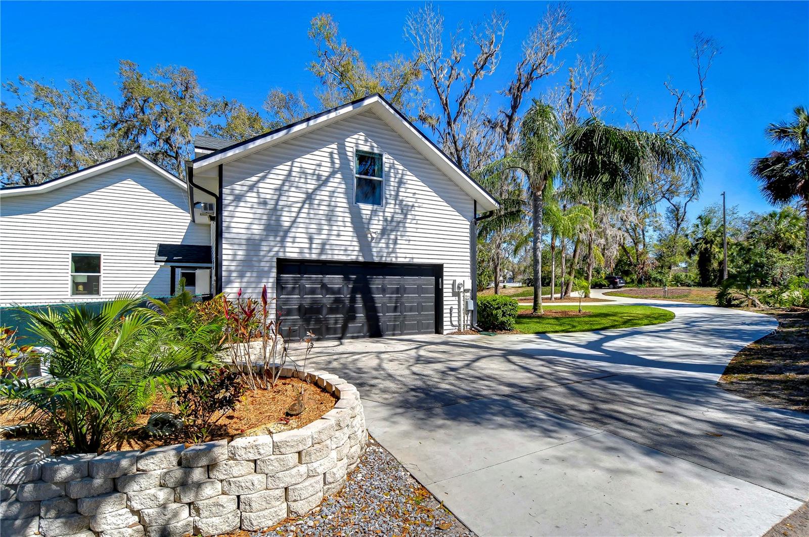 The expansive driveway adds practicality and style, ensuring plenty of room for parking and play.