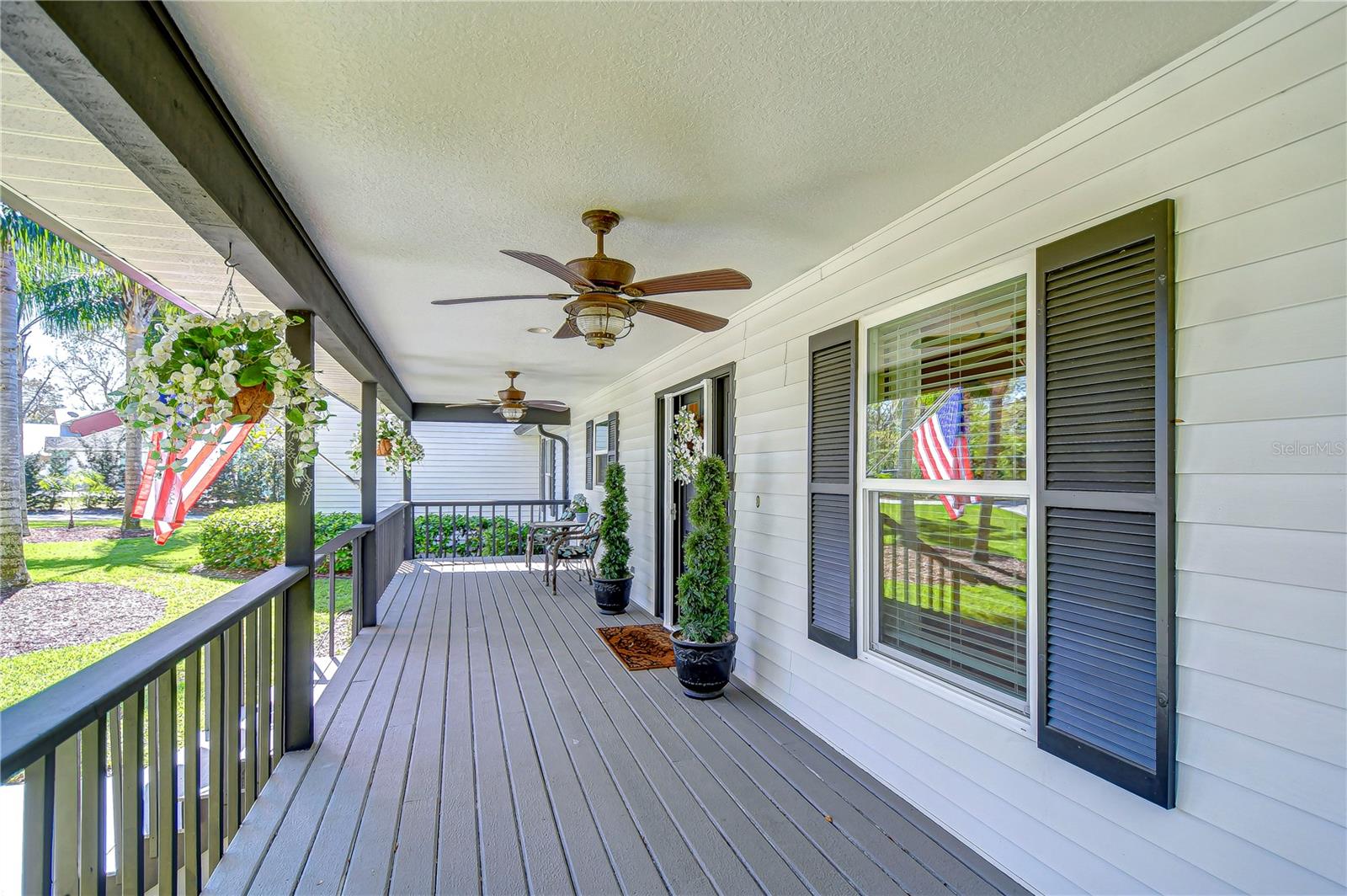 Relax on your charming front porch, complete with ceiling fans and serene views. Perfect for unwinding, this cozy space invites you to sip your morning coffee while enjoying gentle Florida breezes.