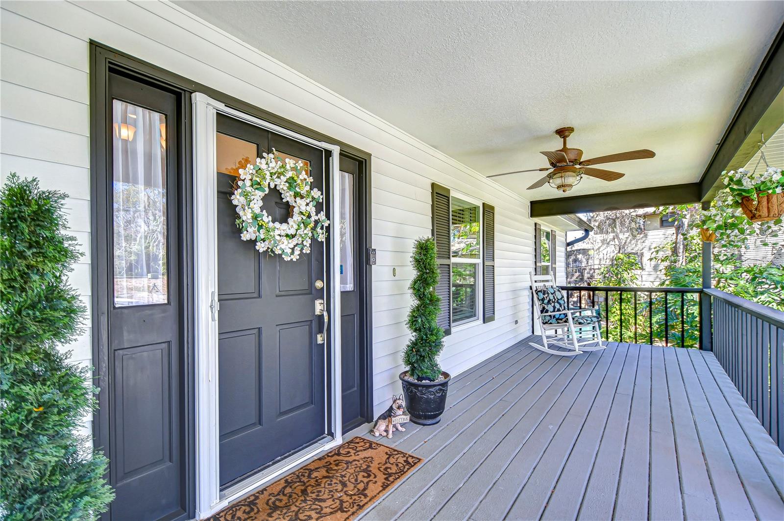 Enjoy breezy afternoons, shaded by a lovely overhang and surrounded by vibrant greenery