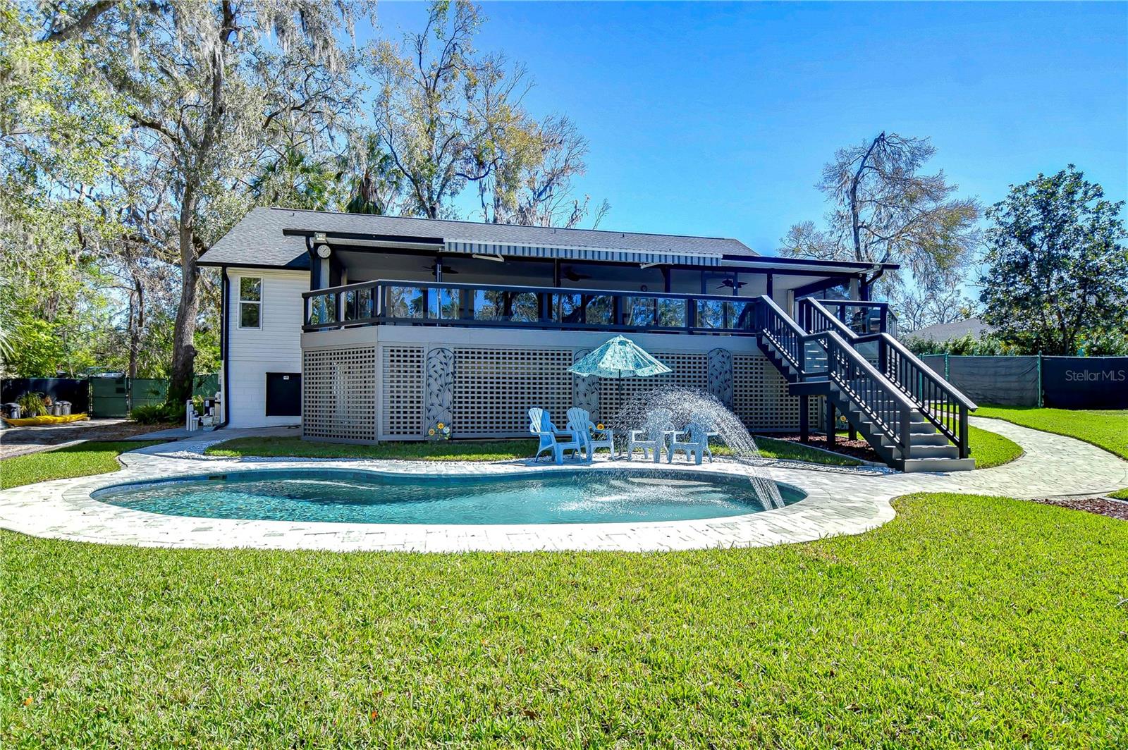 Dive into relaxation at this lush backyard oasis, where the sparkling pool and expansive deck invite endless summer gatherings.