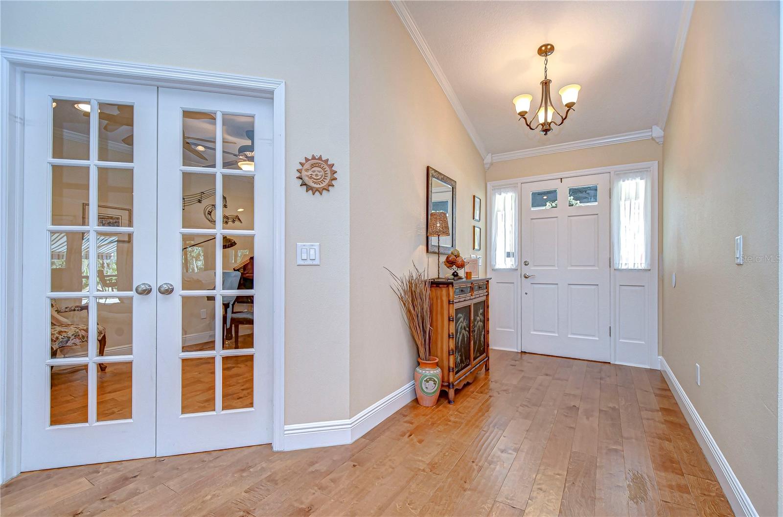 his charming entryway greets you with natural lighting and warm wood flooring, setting a delightful tone for the rest of your beautiful home.