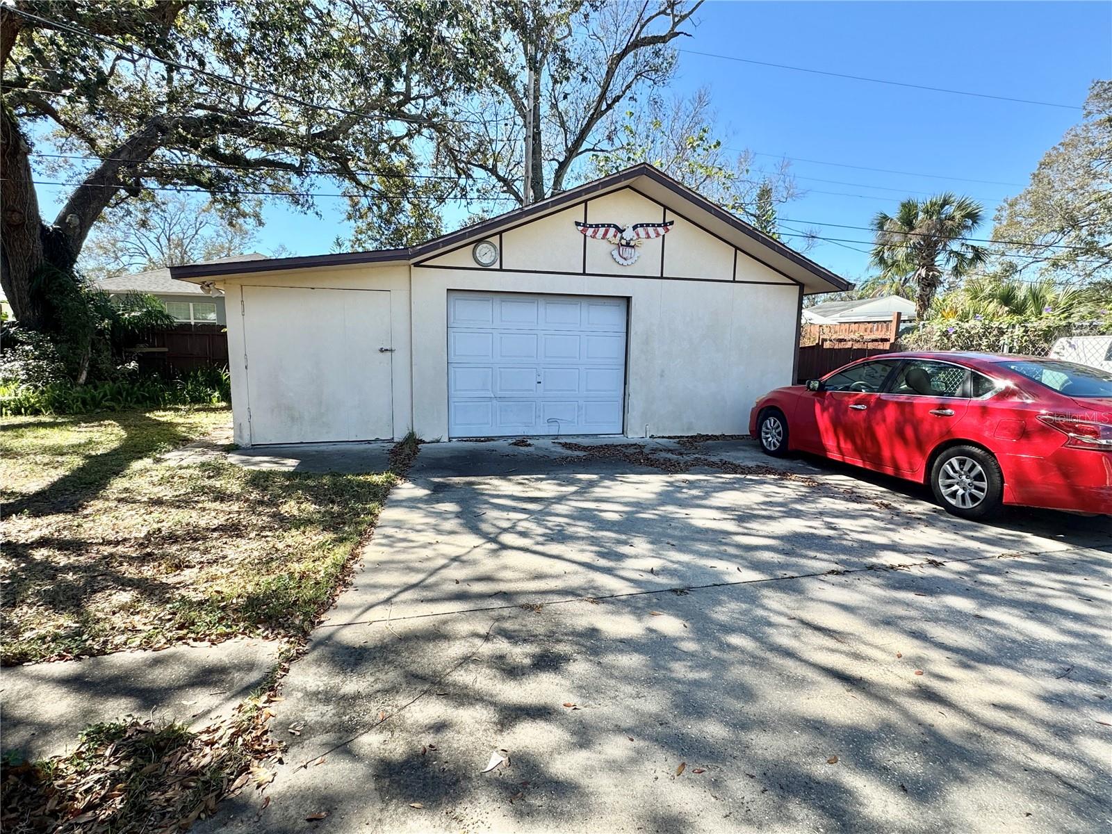 Garage with storage room/work shop on the left side