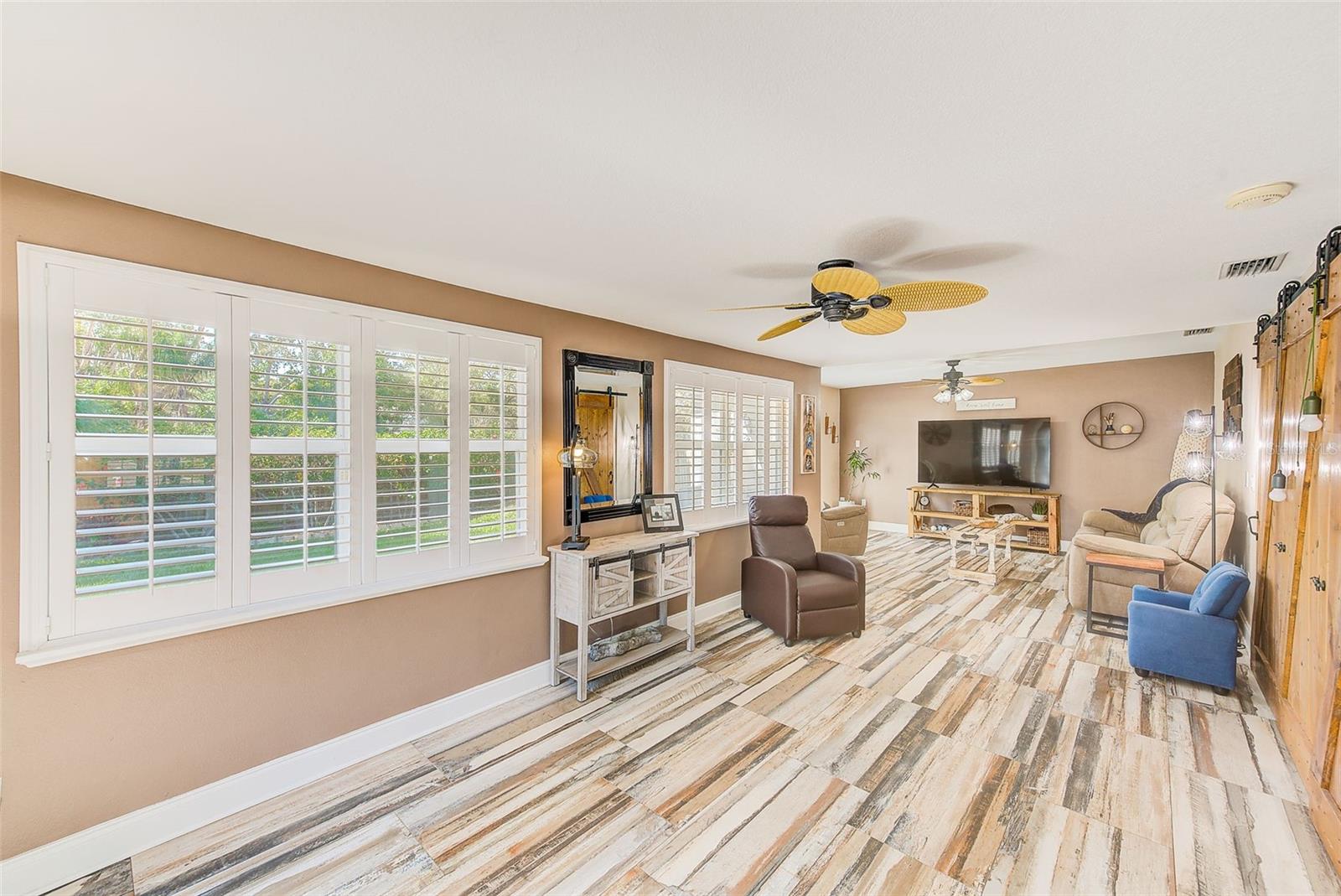 Family room with plantation shutters and two french doors to the back yard.