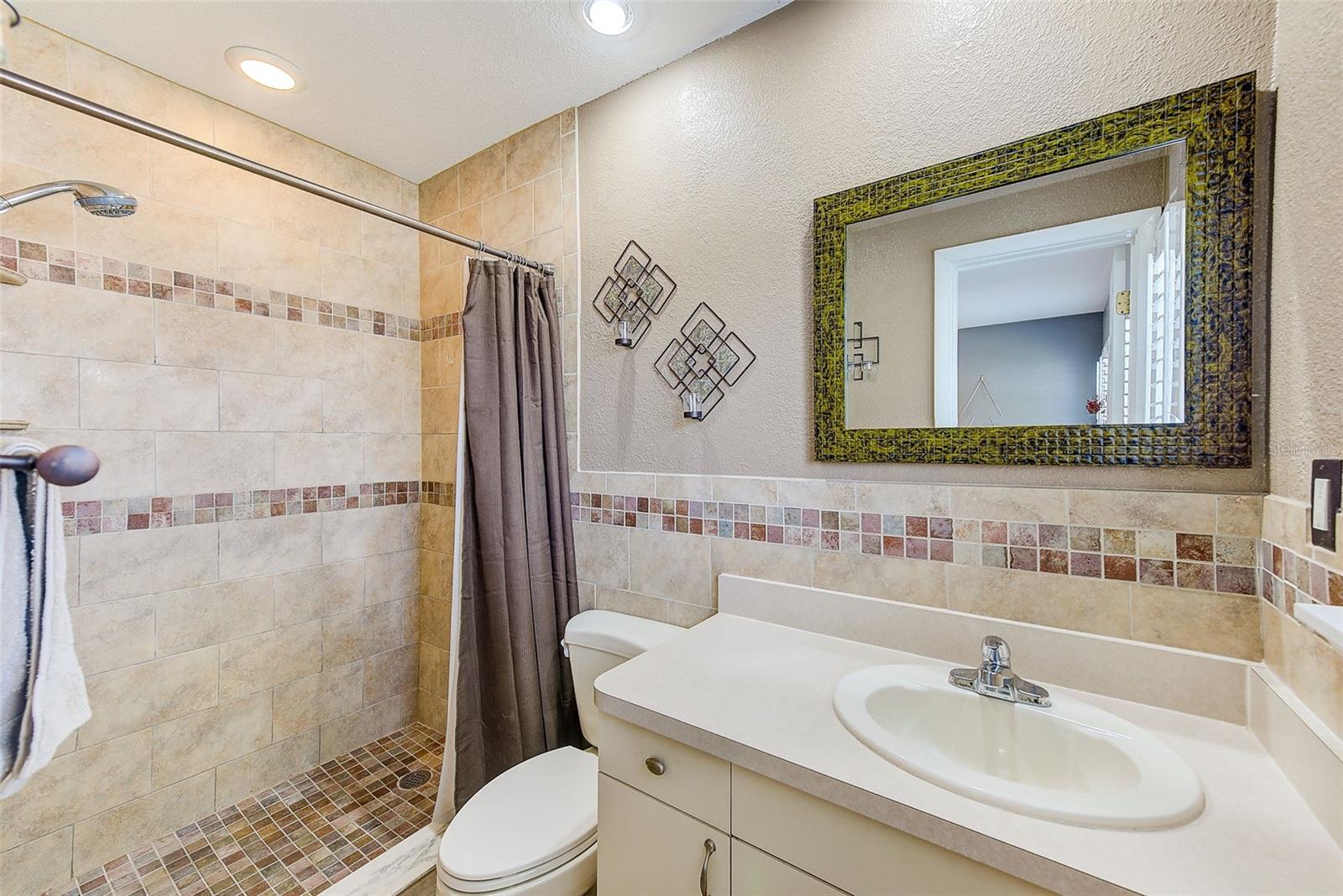 Primary en-suite with beautiful tile work