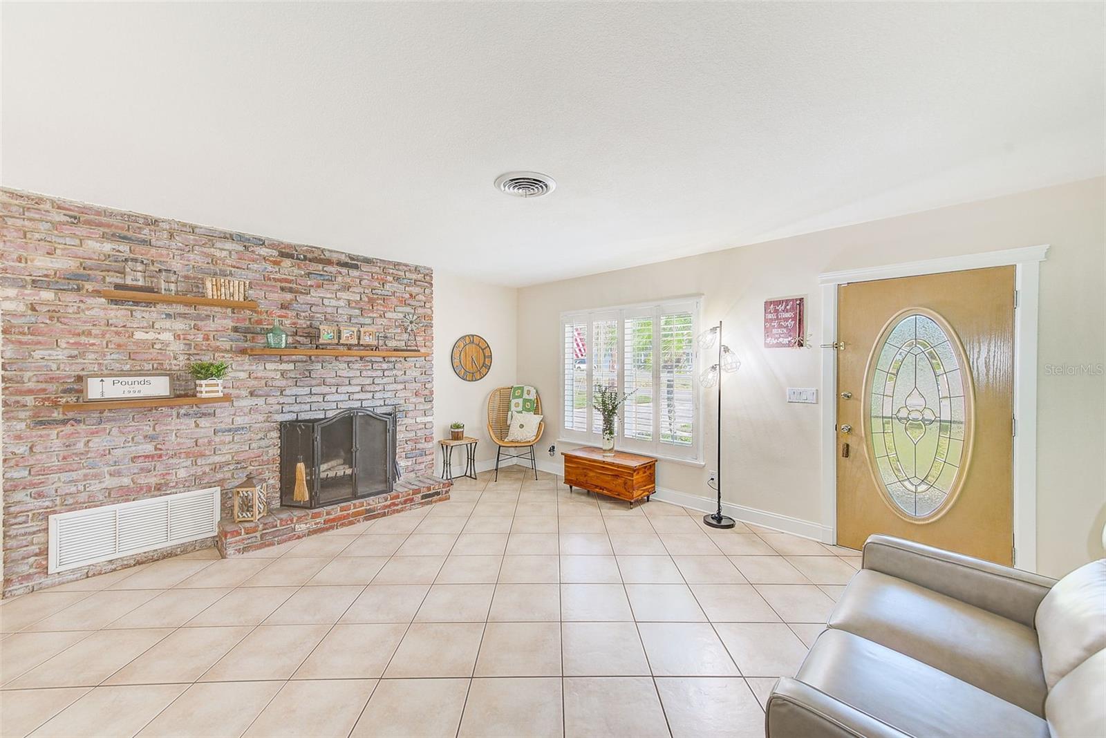 Living Room with porcelain tile flooring and plantation shutters