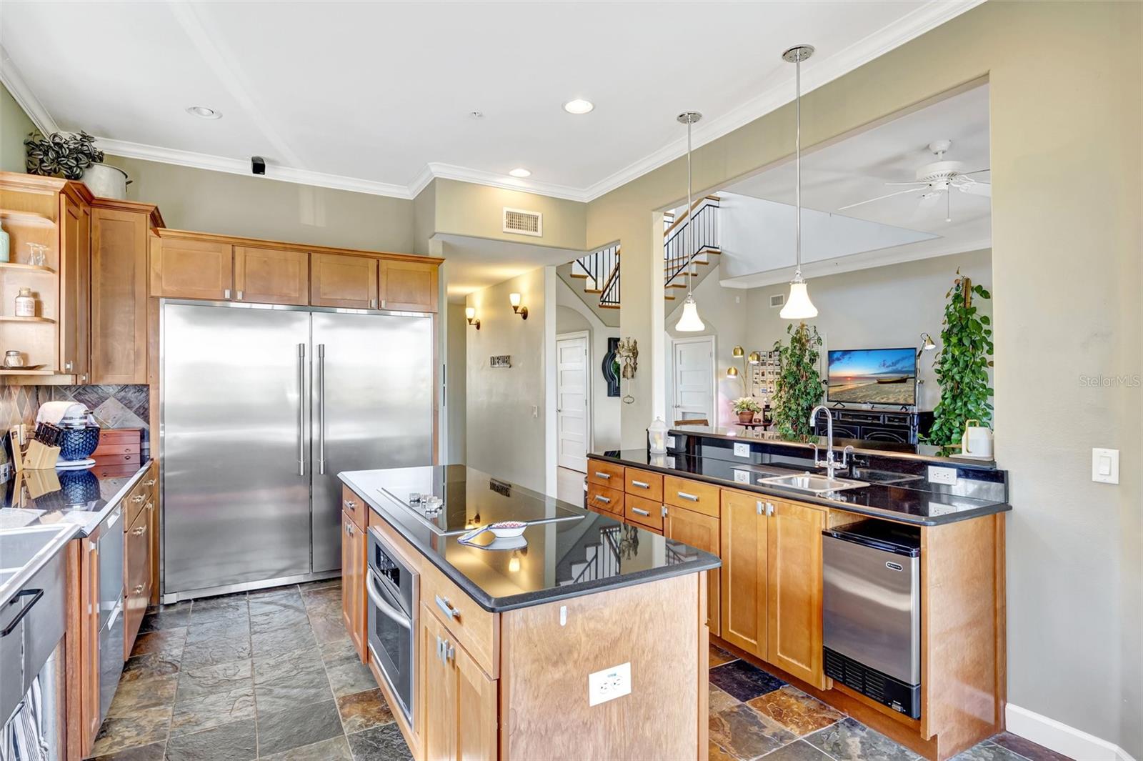 Kitchen overlooks the great room and the balcony to pool and waterfront.