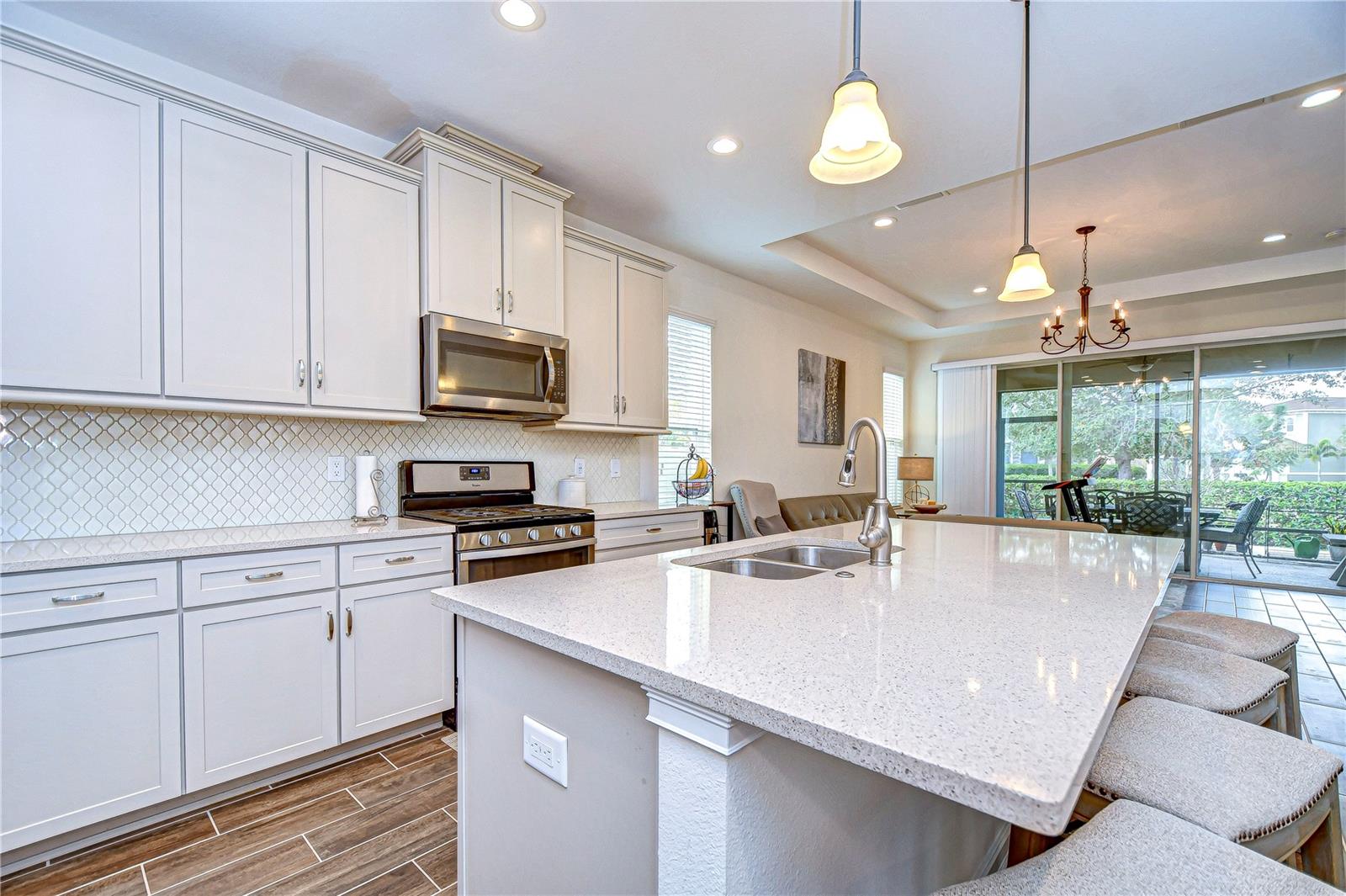 Gather around the gleaming island in this luxury kitchen.