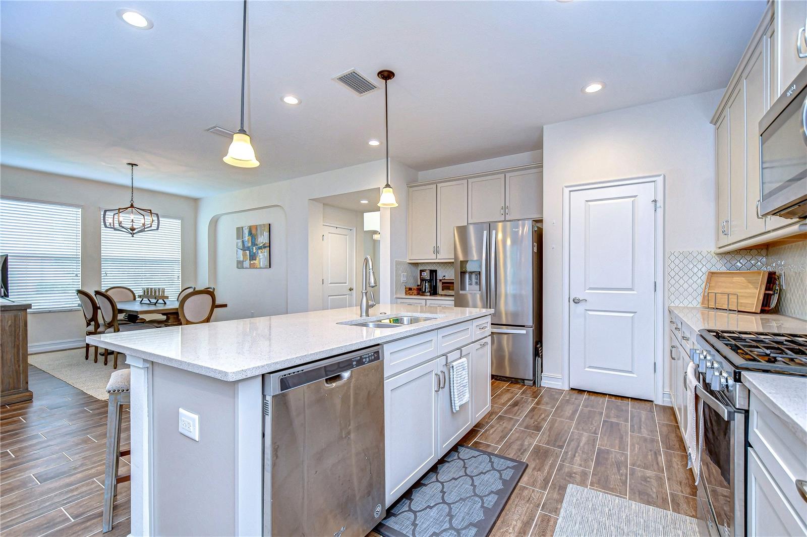 stunning kitchen, complete with modern appliances, sleek countertops, and elegant lighting.