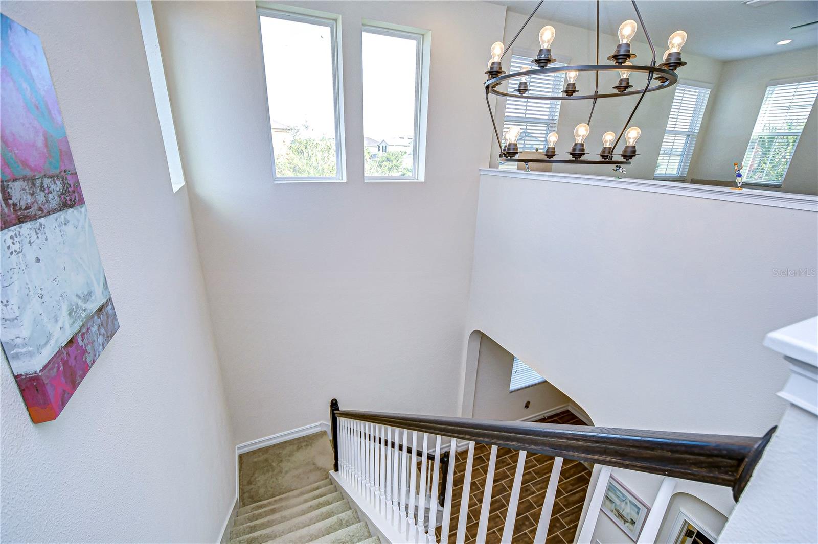 Natural light floods in on the grand staircase, creating a warm, inviting atmosphere