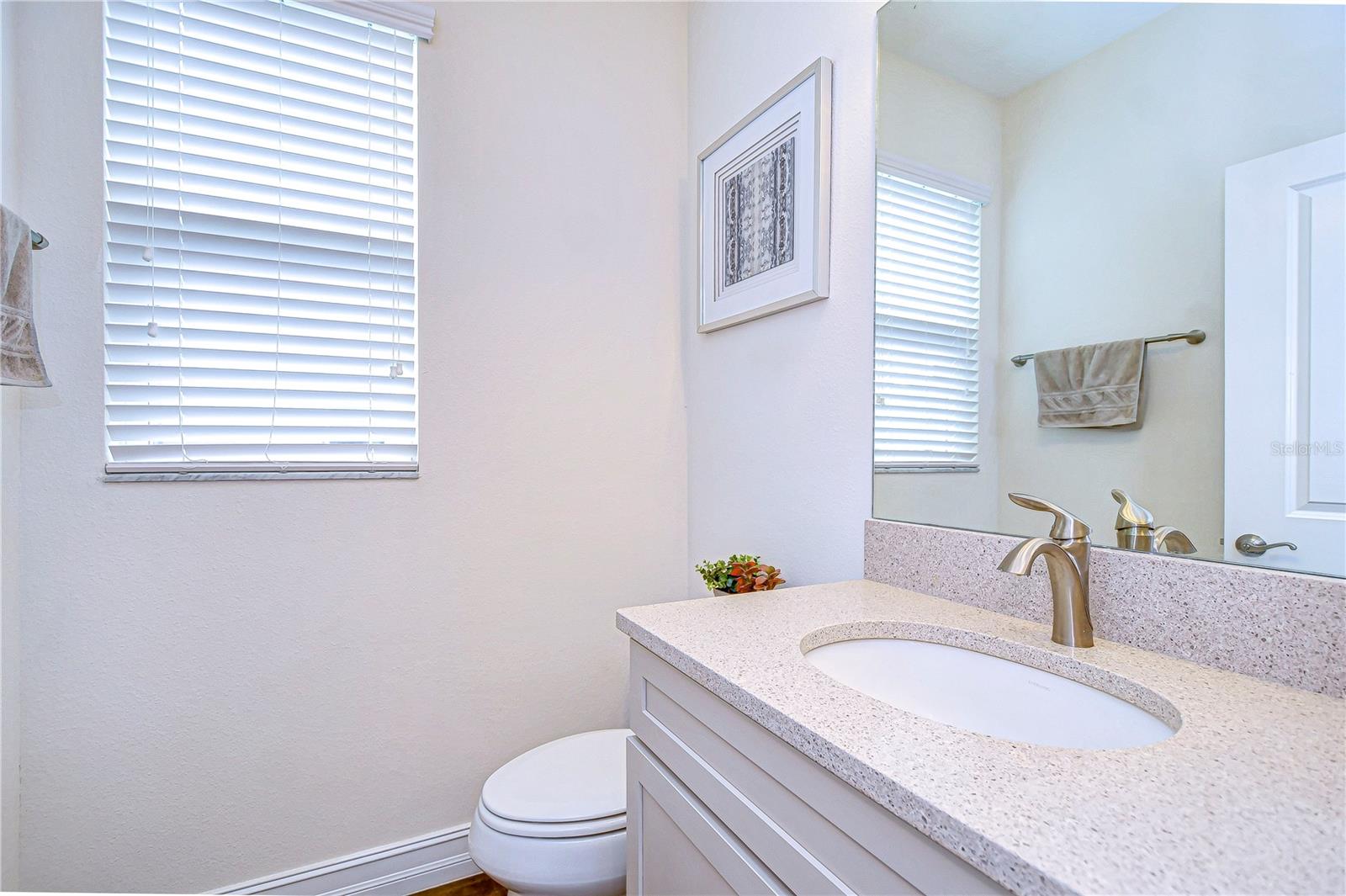 Bright and modern, this half bath features sleek fixtures and a minimalist design.