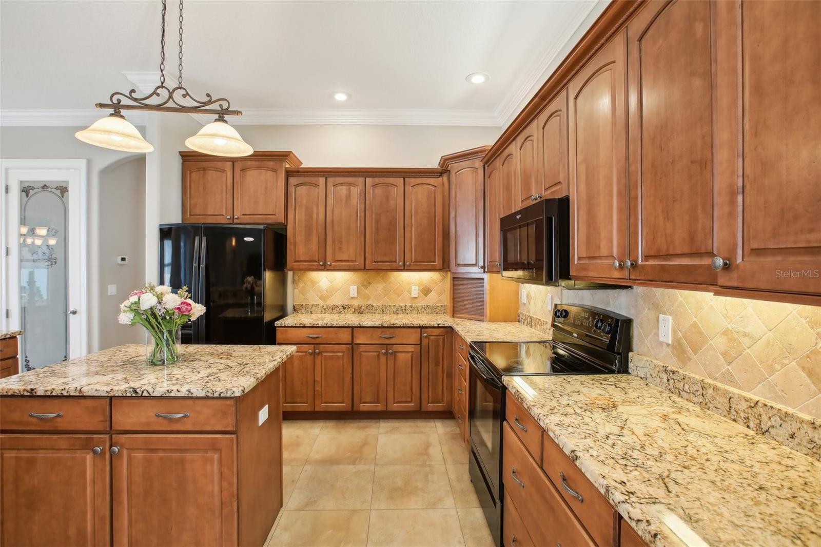 Eat in kitchen with 42 inch cabinets beautiful granite and black appliances