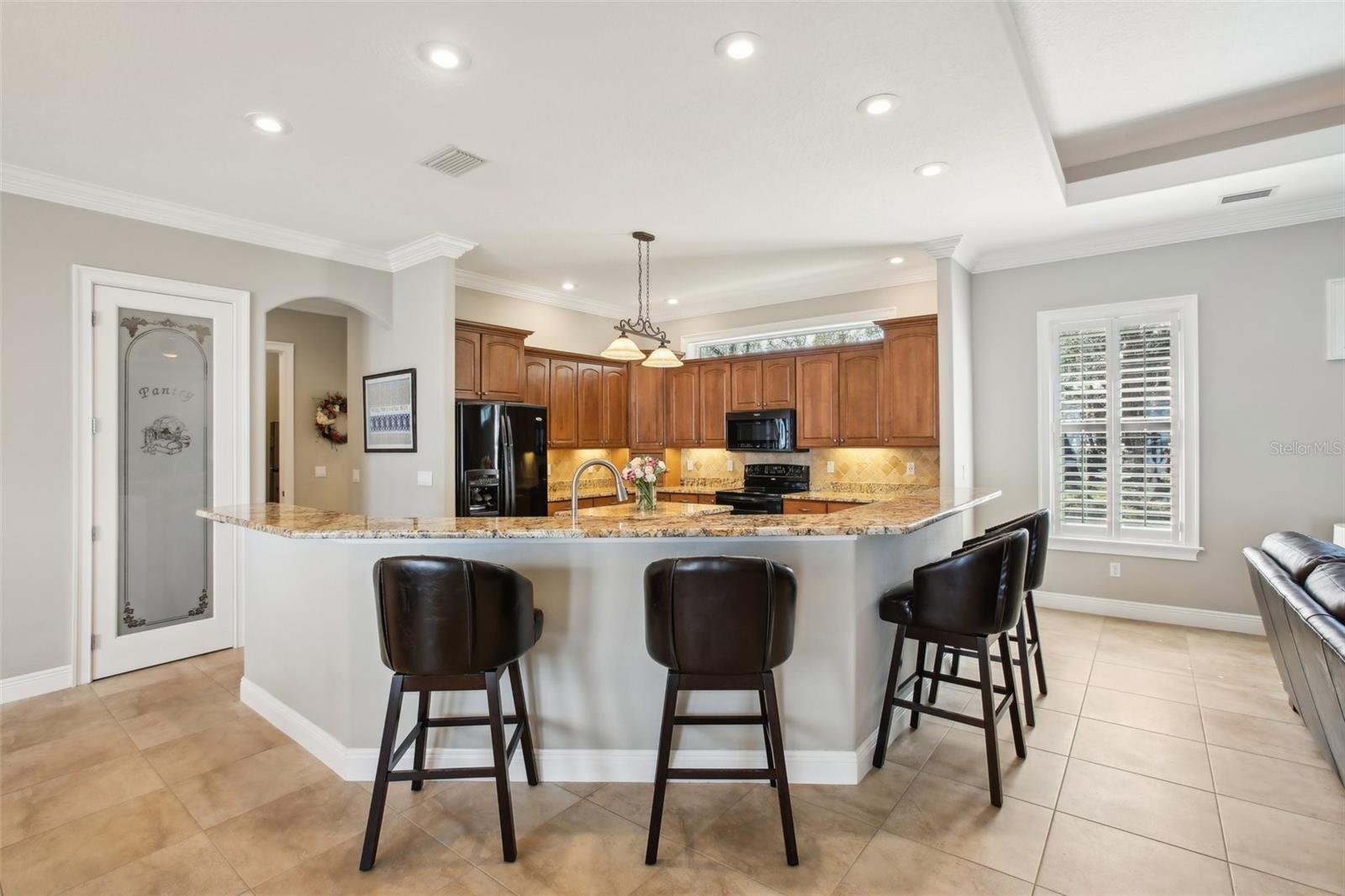 Eat in kitchen with 42 inch cabinets beautiful granite and black appliances