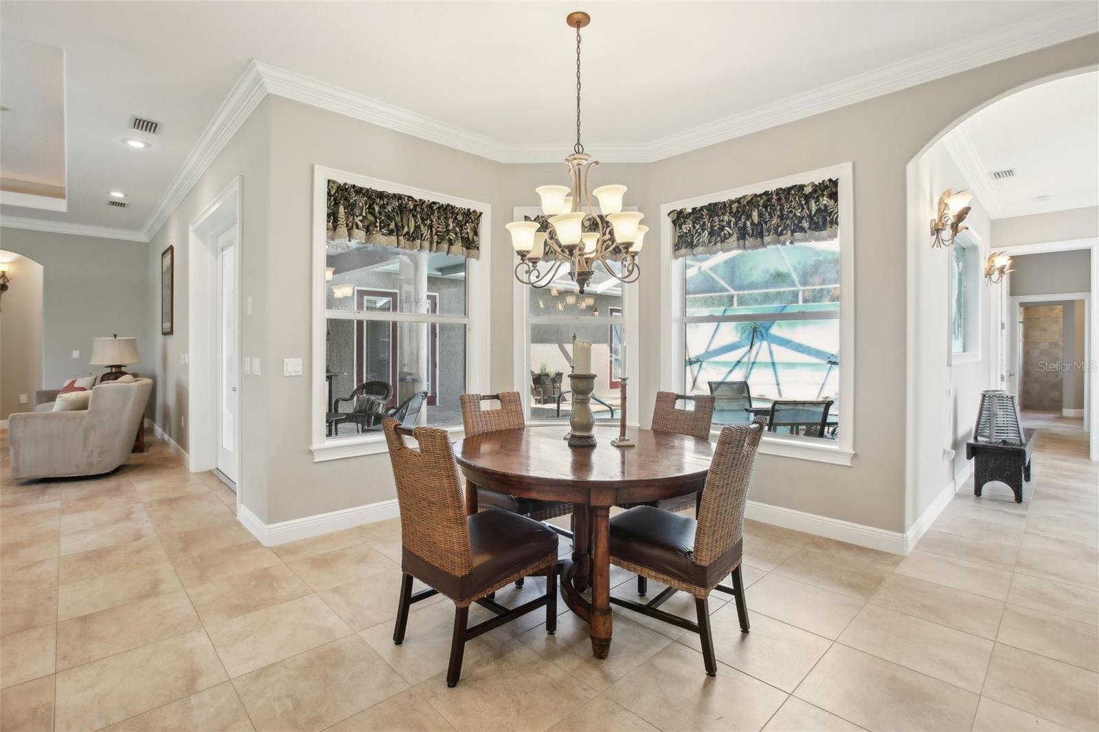 Dining area off the kitchen and family room with double window view to lanai area