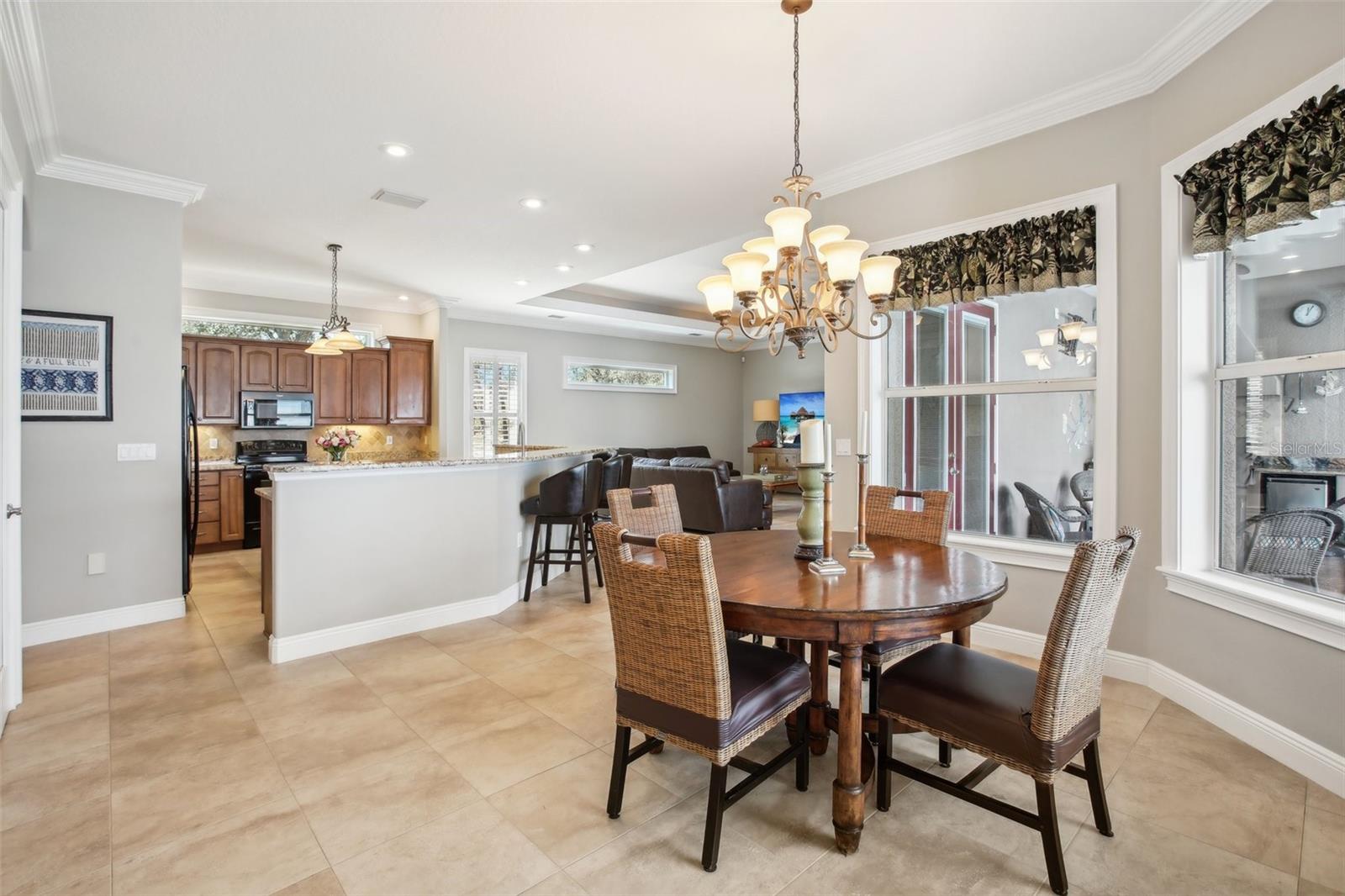 Dining area off the kitchen and family room with double window view to lanai area