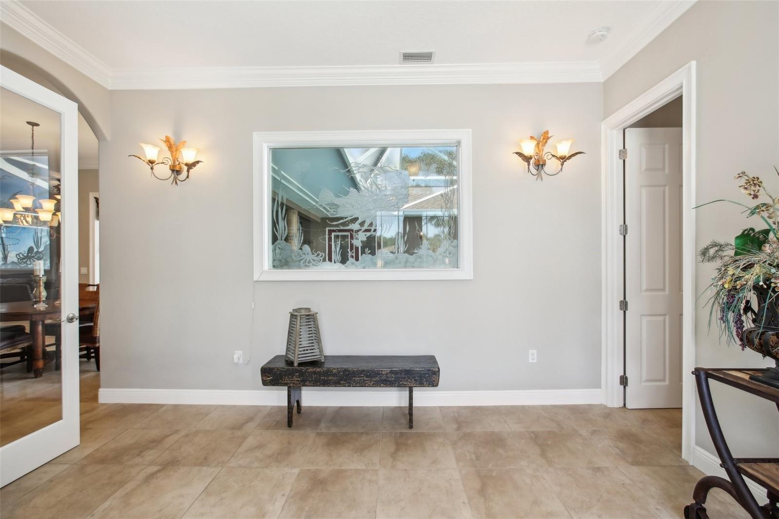 Beautiful inviting Foyer.  2nd primary bedroom to the right, office/den to left