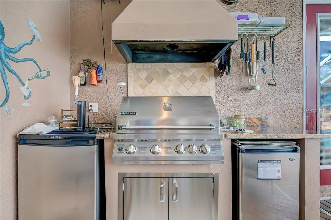 Outdoor kitchen with Jenn Air, refrigerator and kegerator