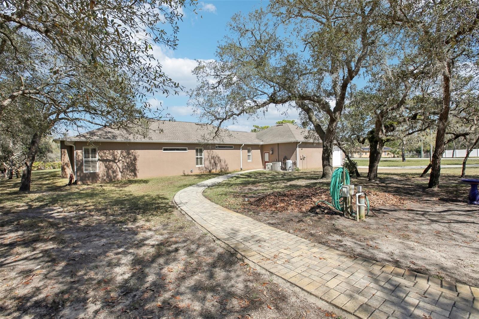 Side of home with walk way to outdoor area