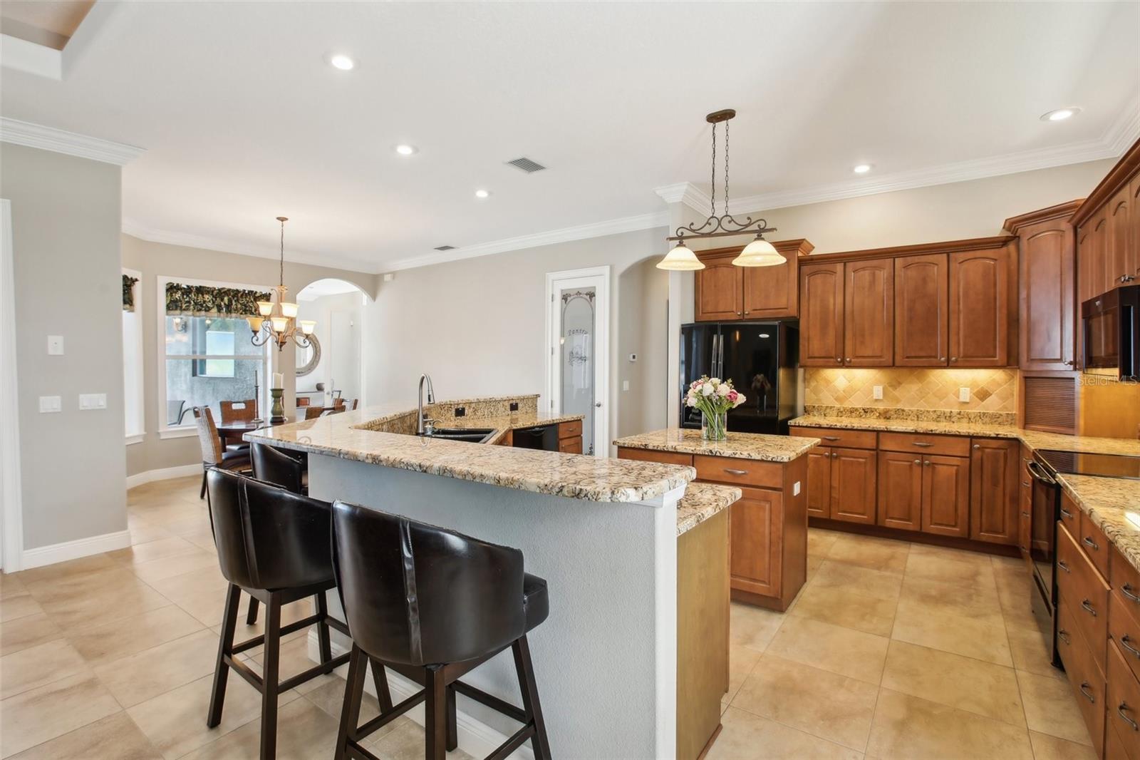 Eat in kitchen with 42 inch cabinets beautiful granite and black appliances