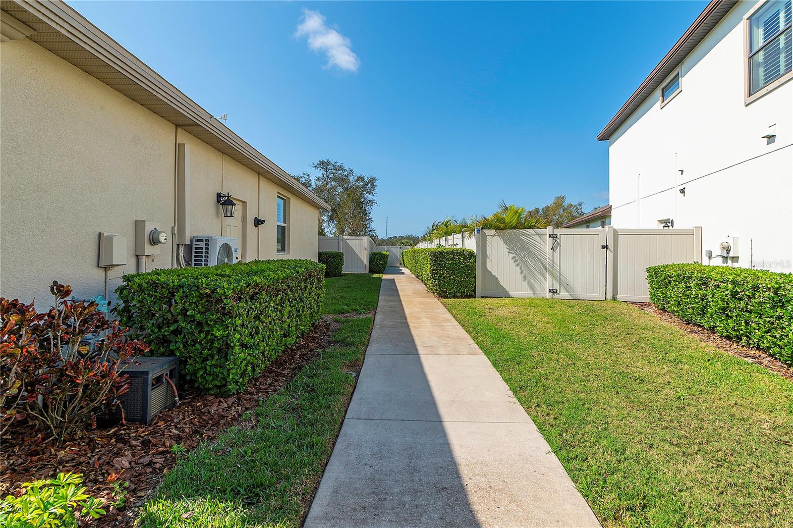 A few lots down, community sidewalk/gated entrance to the Pinellas Trail