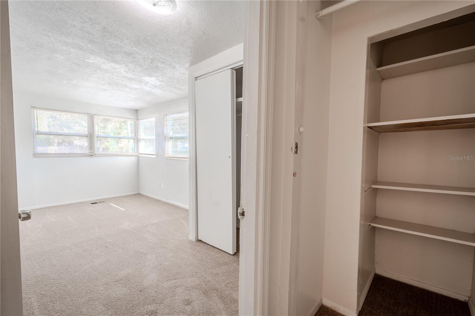 Unit 2 - Primary bedroom has carpet and a built in closet.