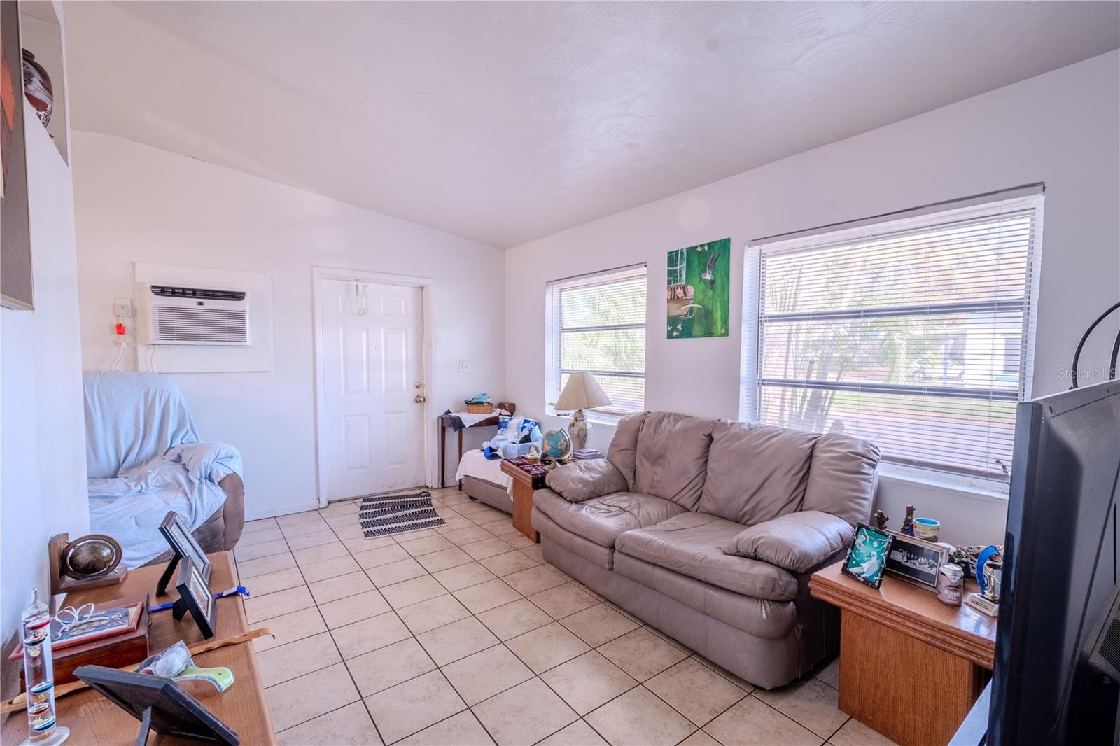 Unit 1 - Living room has a wall unit A/C