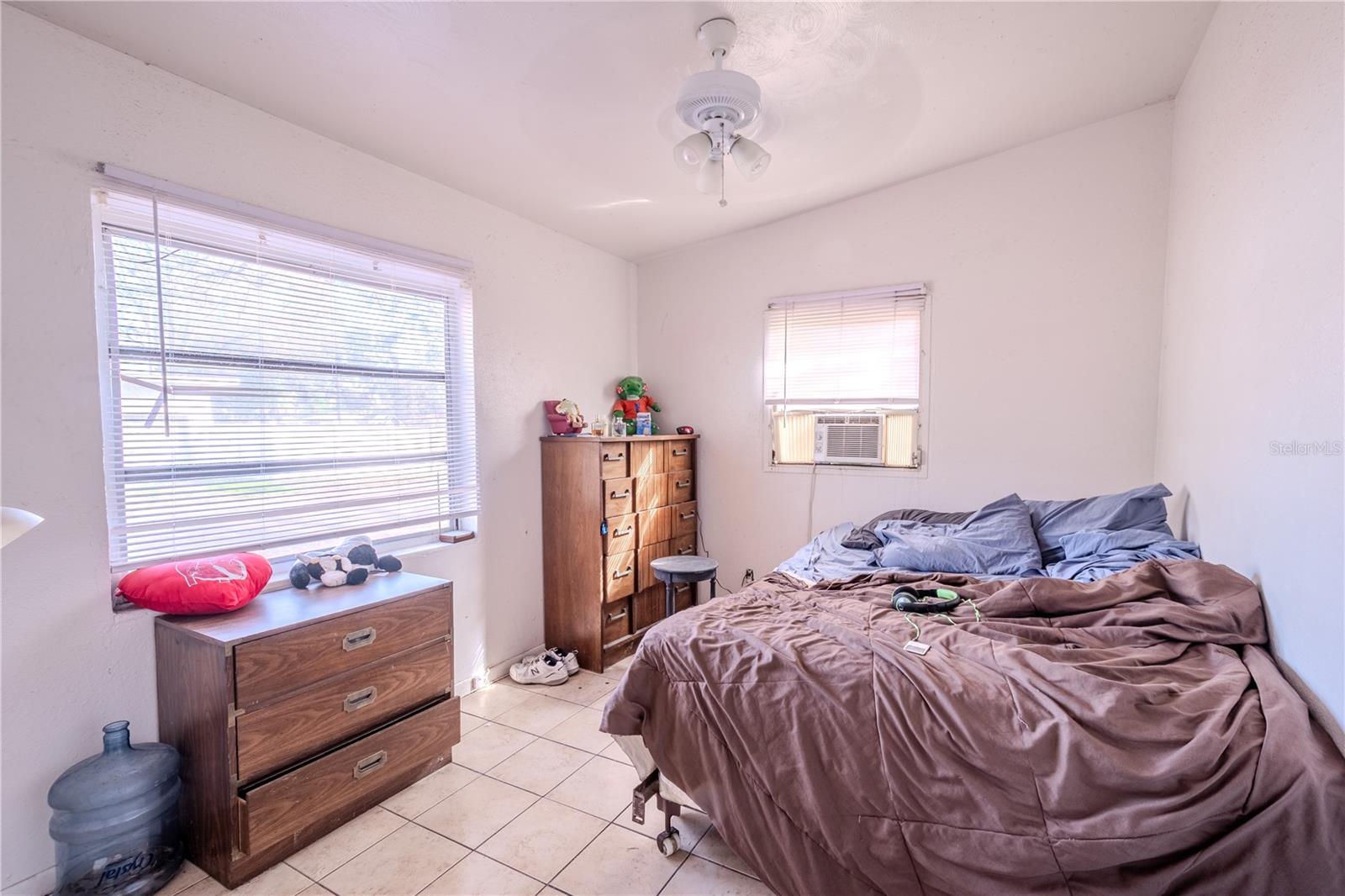 Unit 1 - Bedroom #1 has a built in closet, tile floor, ceiling fan and window unit A/C