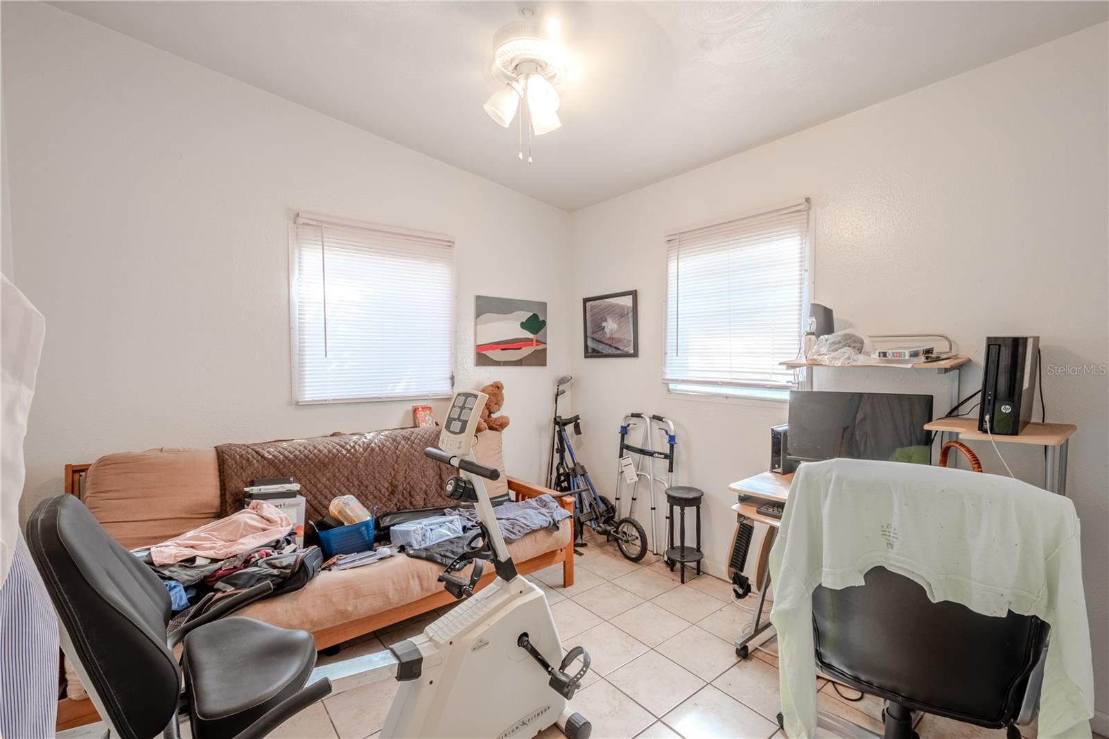 Unit 1 - Bedroom #2 has a ceiling fan with light kit, built in closet and a tile floor.