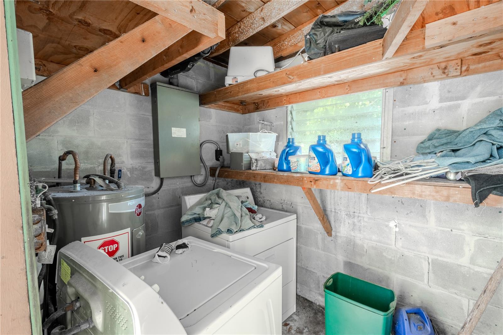 Unit 1 - Laundry room has shelving and a washer dryer.