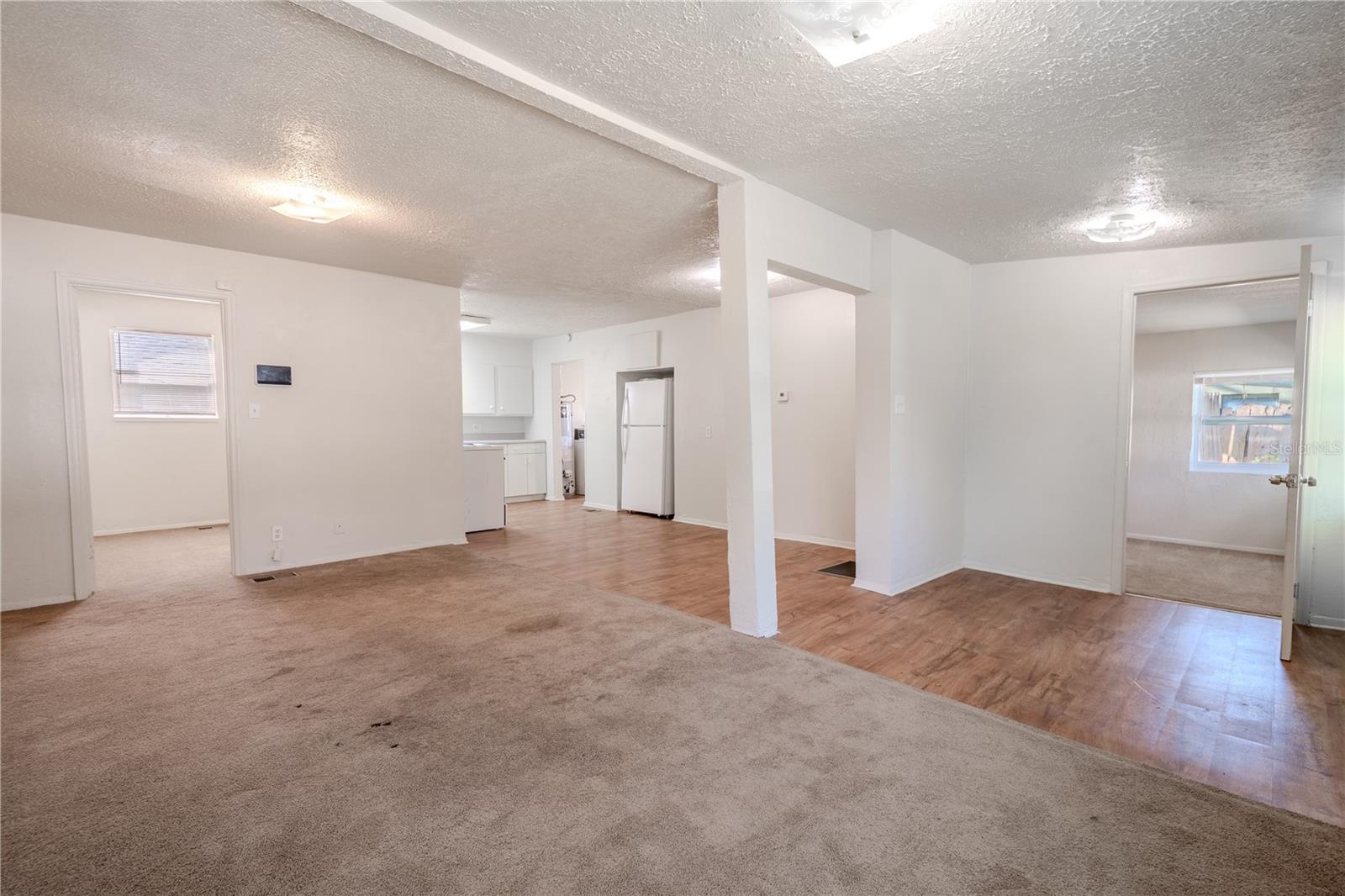 Unit 2 - Living room features neutral tones and carpet