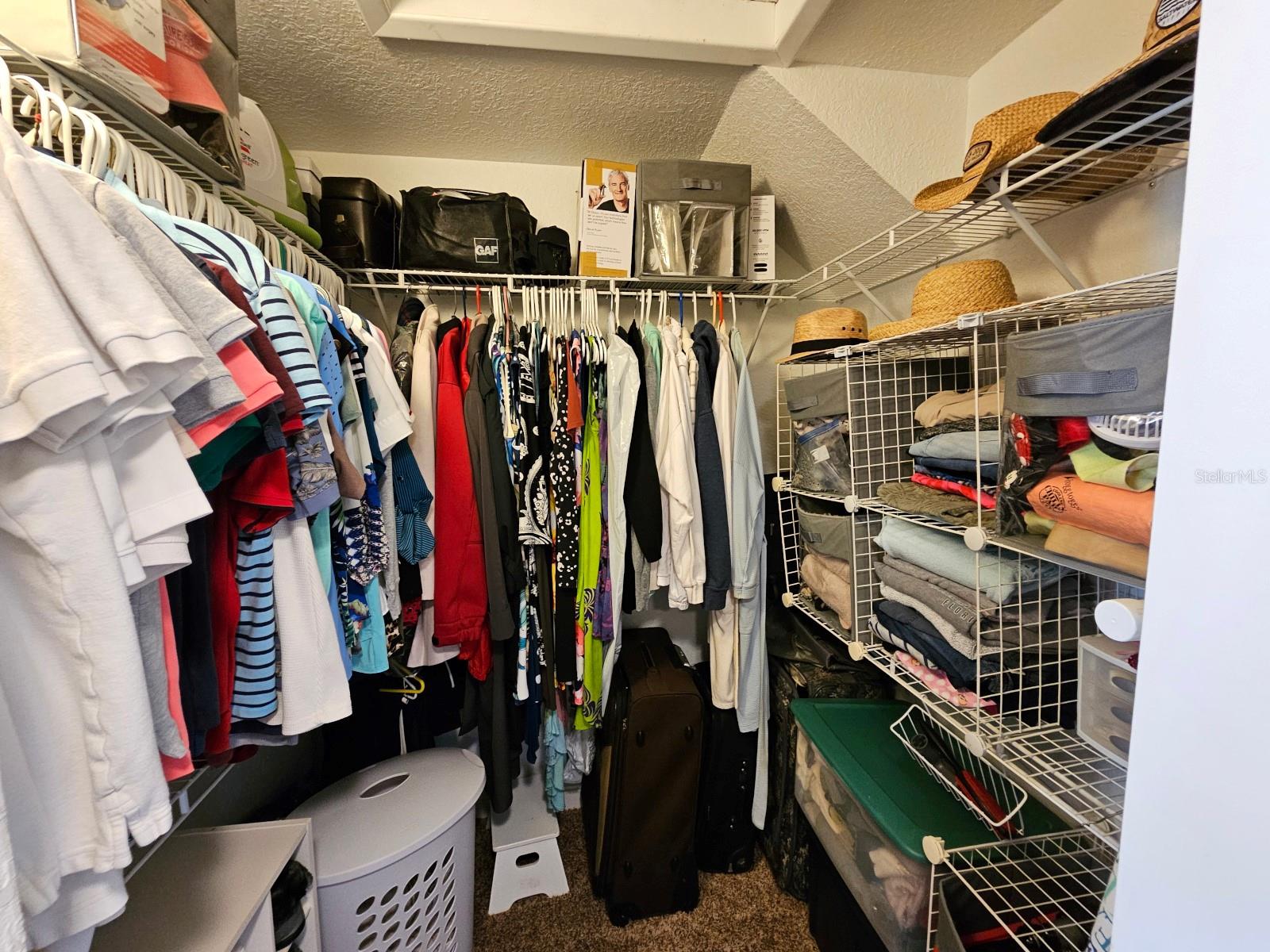 Primary bedroom walk-in closet