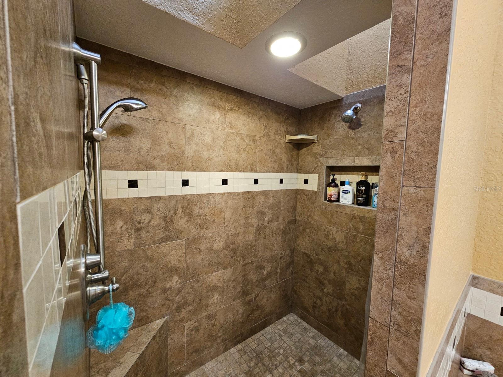 Walk-in shower with dual shower heads