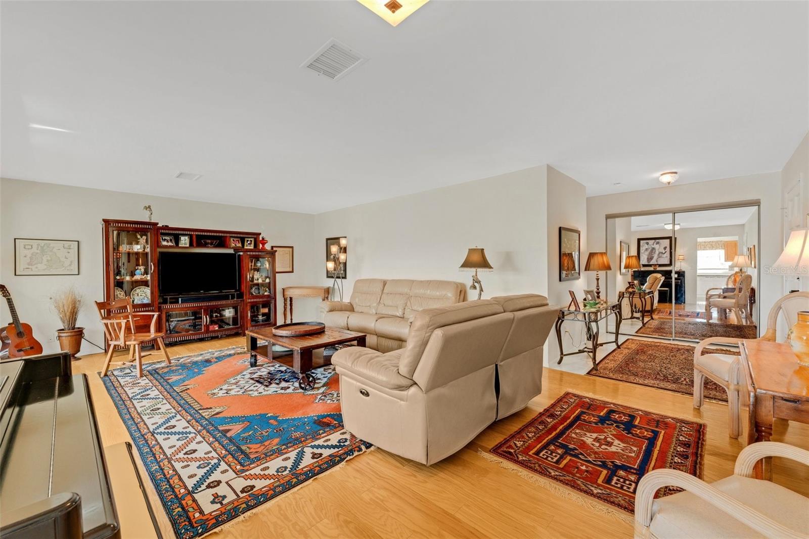 Kitchen Entry Looking to Living Room and Unit Entryway Leading to Beds and Baths