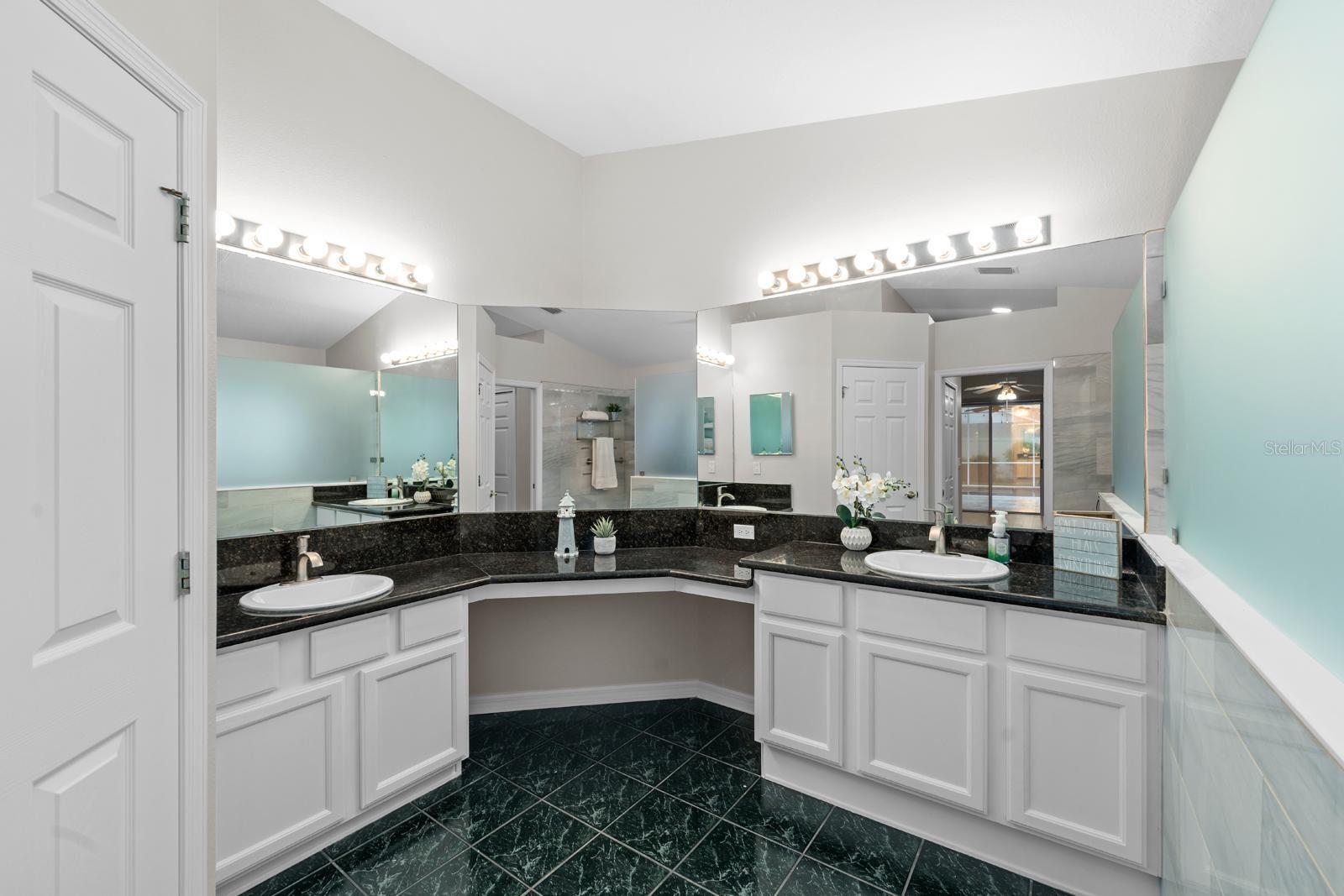 The primary ensuite features two separate vanities and sinks, granite countertops, new faucets, and extra counterspace!