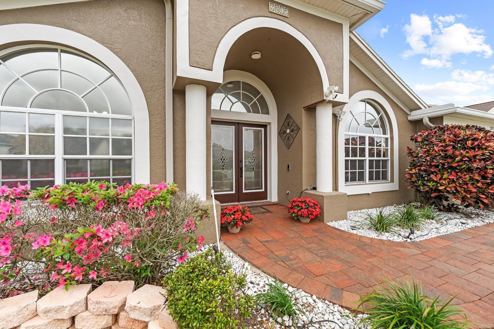 Beautiful curb appeal......the azaleas are in bloom....beautiful front doors....brick-pavered walkway and driveway.