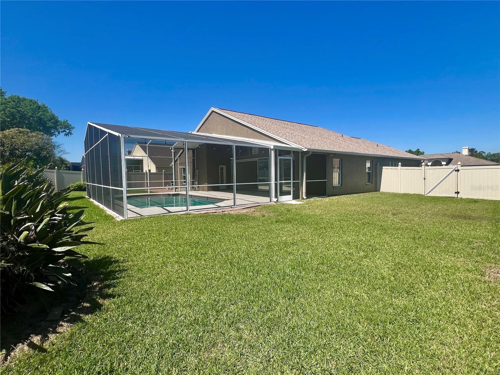 The very spacious backyard is fully-fenced with vinyl fencing (2018).