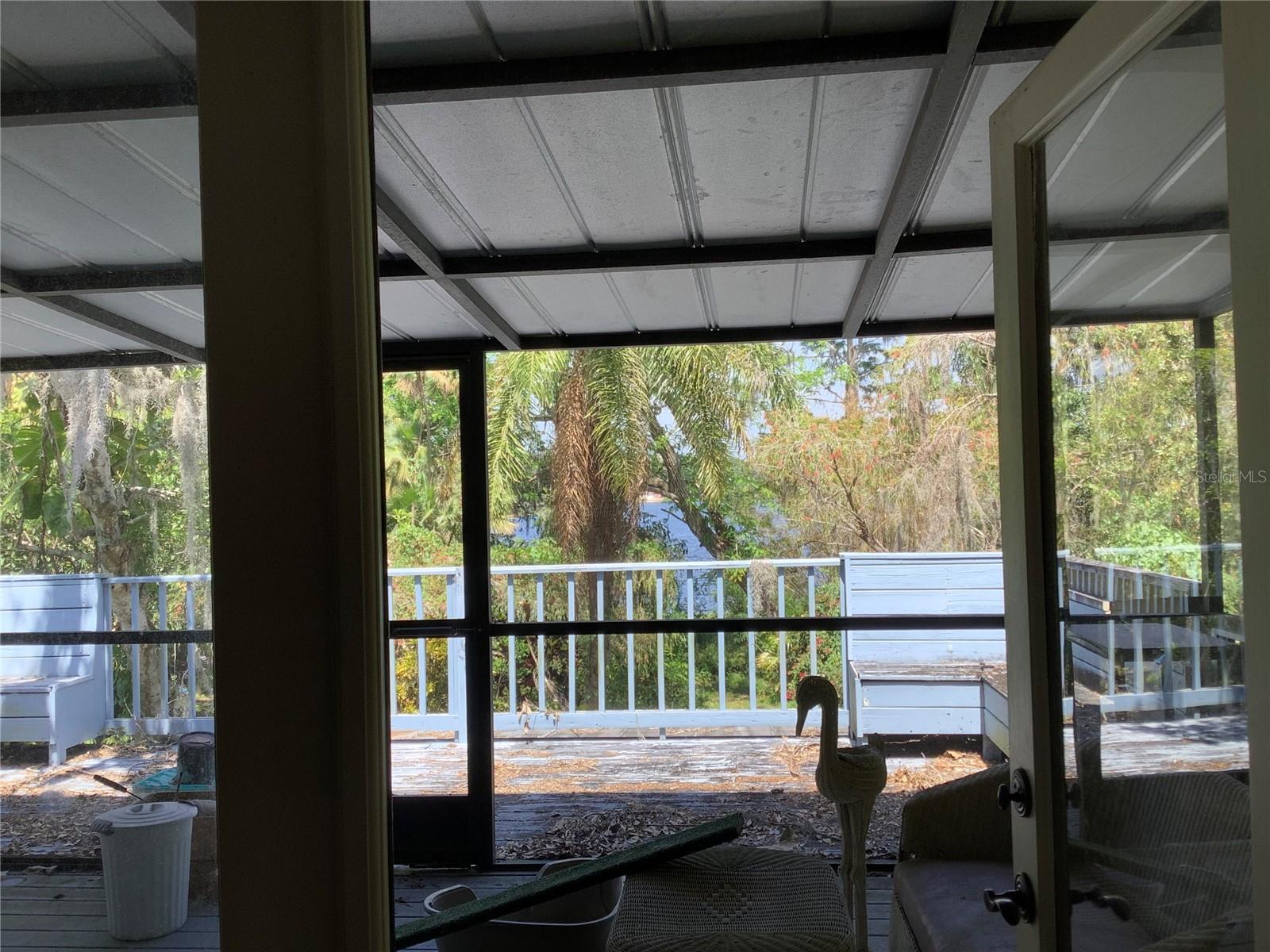 French doors open to screened patio and deck off 2nd floor bedroom