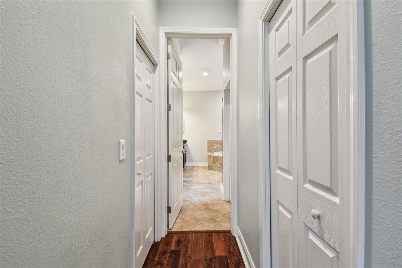 Primary Bedroom Hallway to Primary Bathroom w/dual walk-in closets