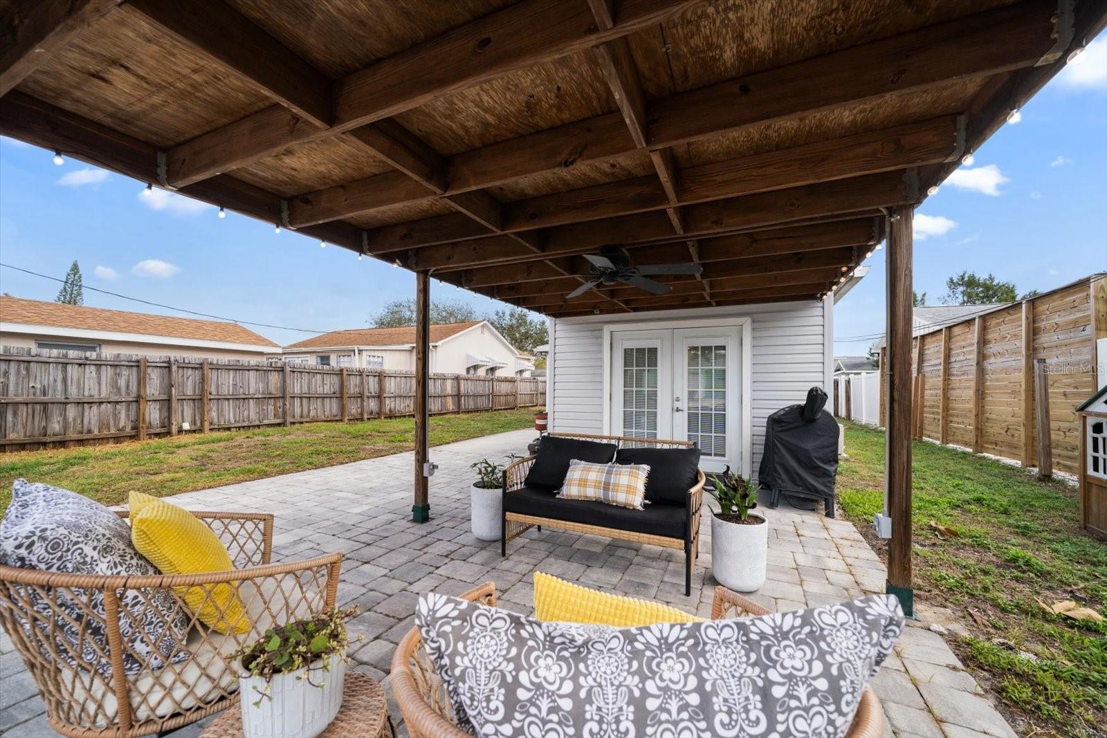 Covered back patio complete with string lights.