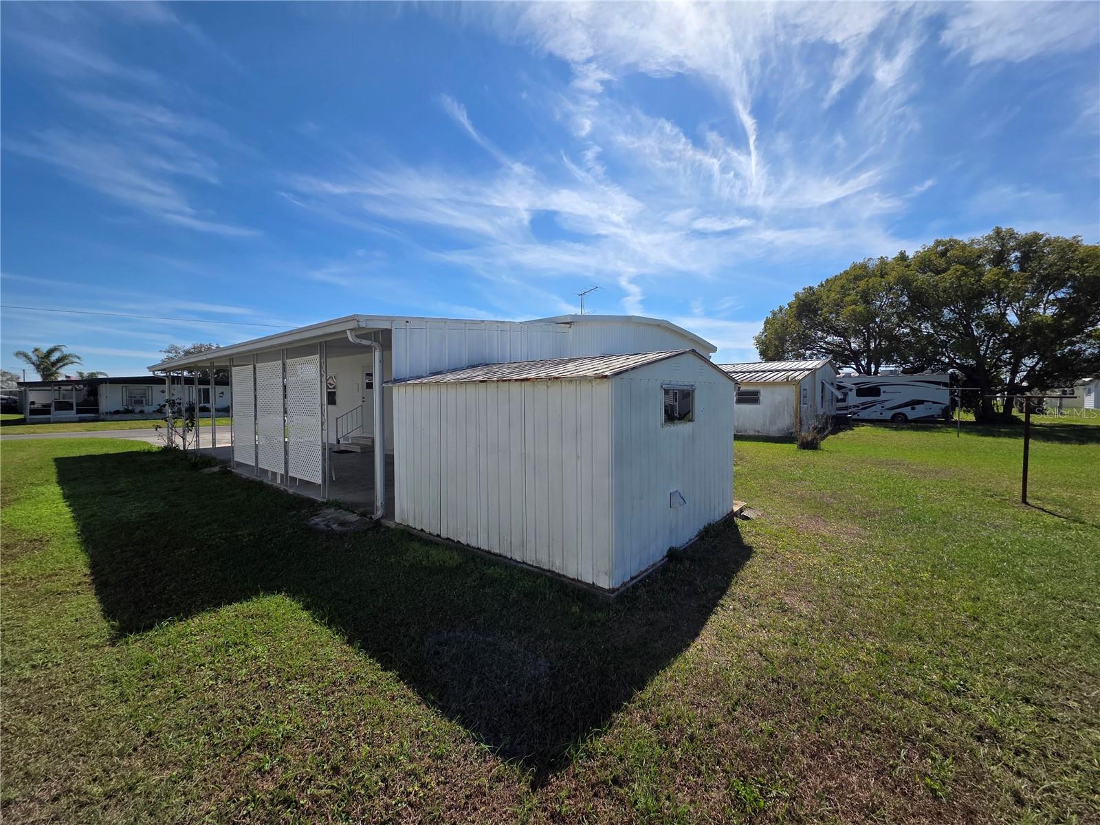 Attached utility shed with washer/dryer.