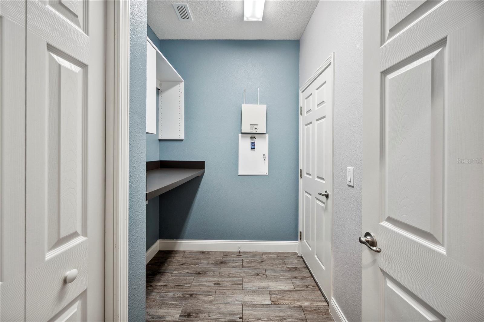 Laundry room with folding table and cabinets