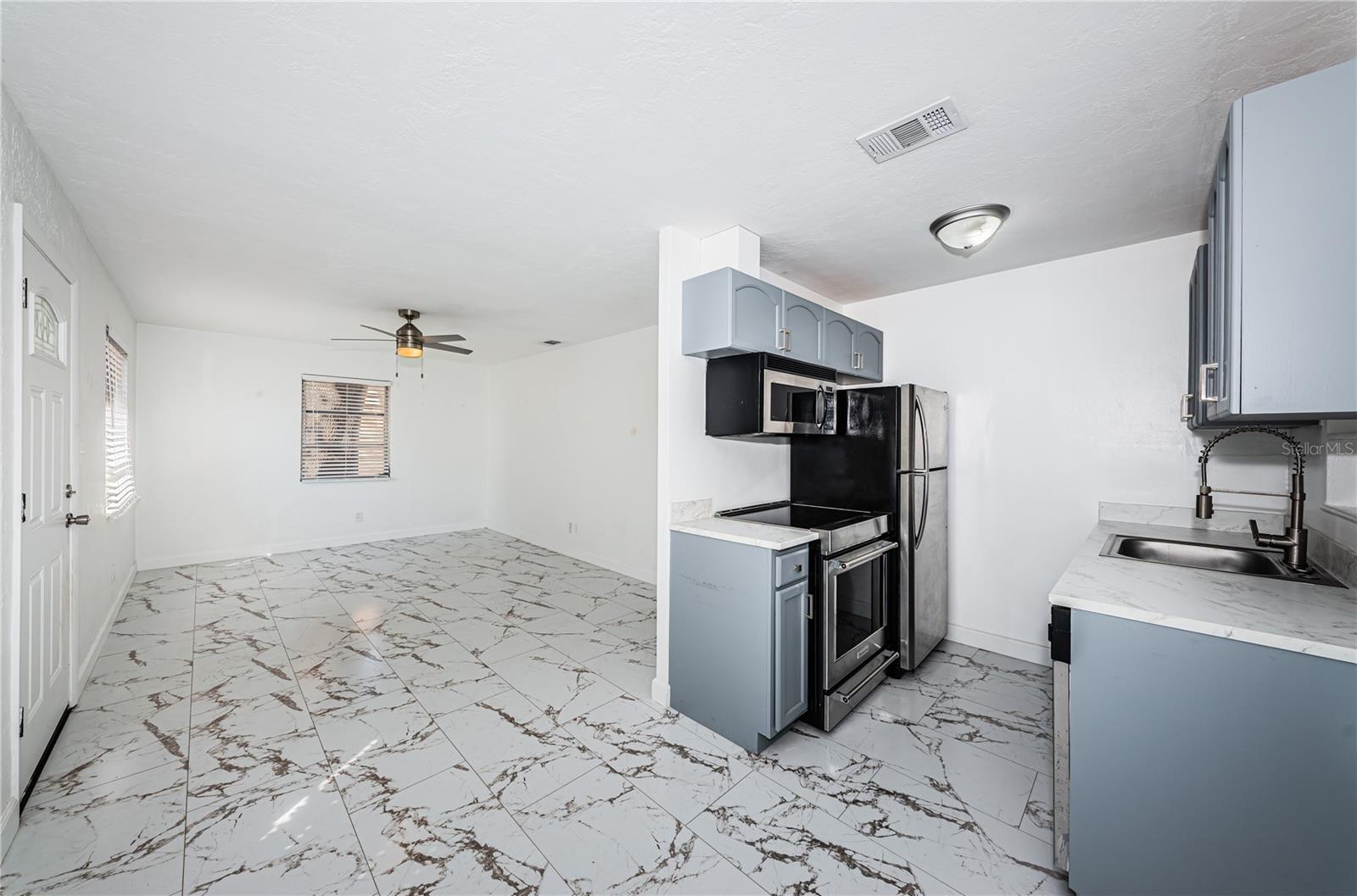 Kitchen with eat in area and living room area