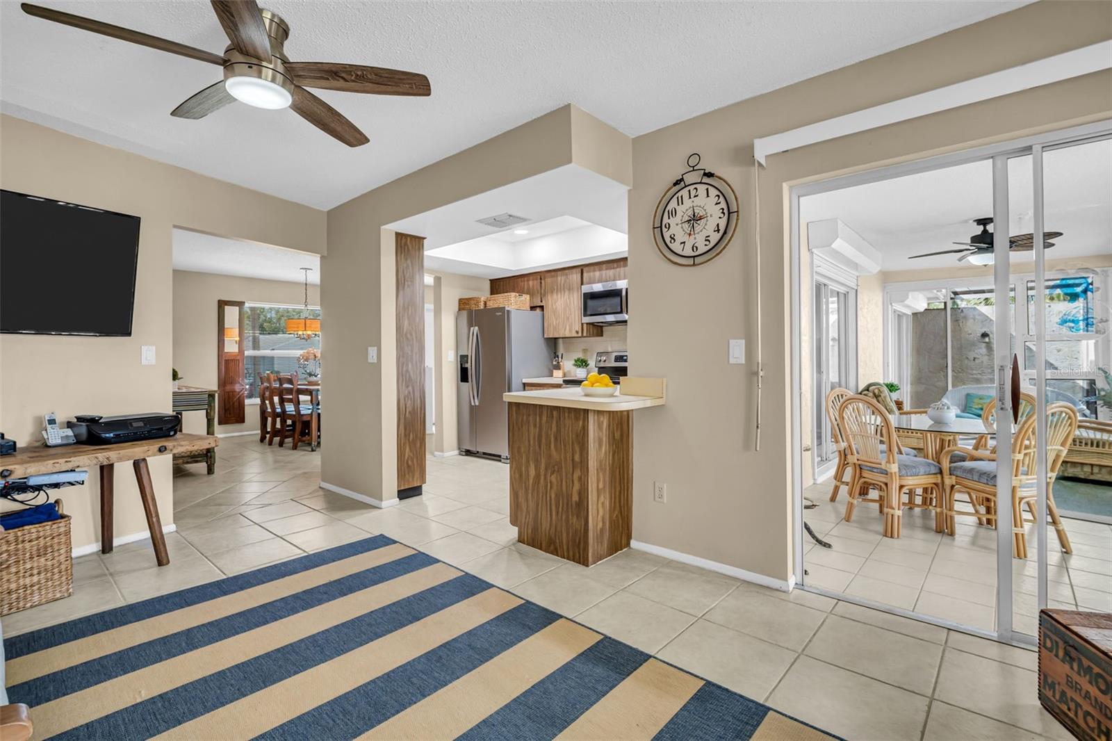 Family room shares open space with the dining room, kitchen and sliding door opening to the enclosed lanai~