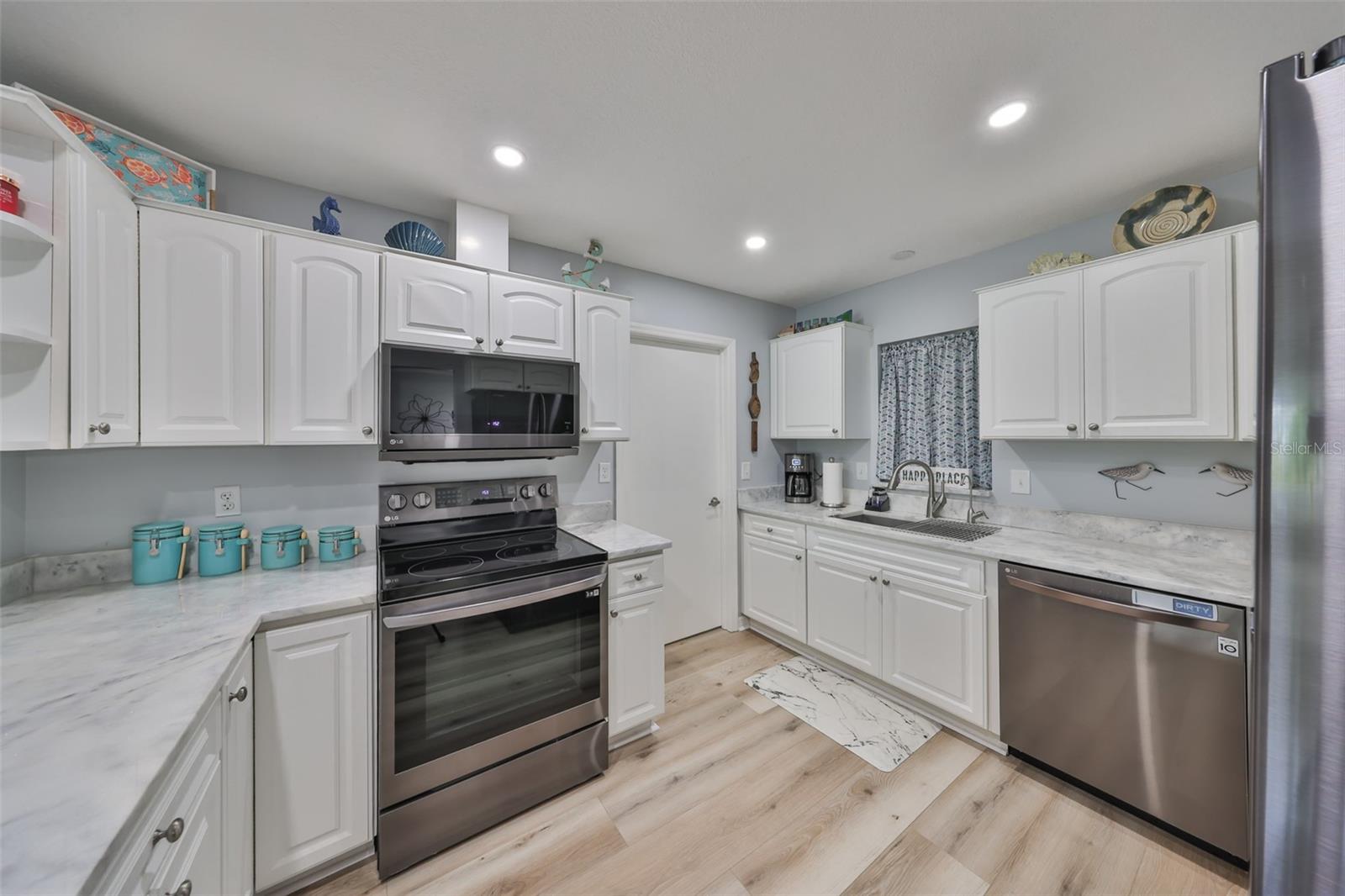 Lovely granite counters and newer appliances make this kitchen a joy to work in.  The laundry room is adjacent to the kitchen.