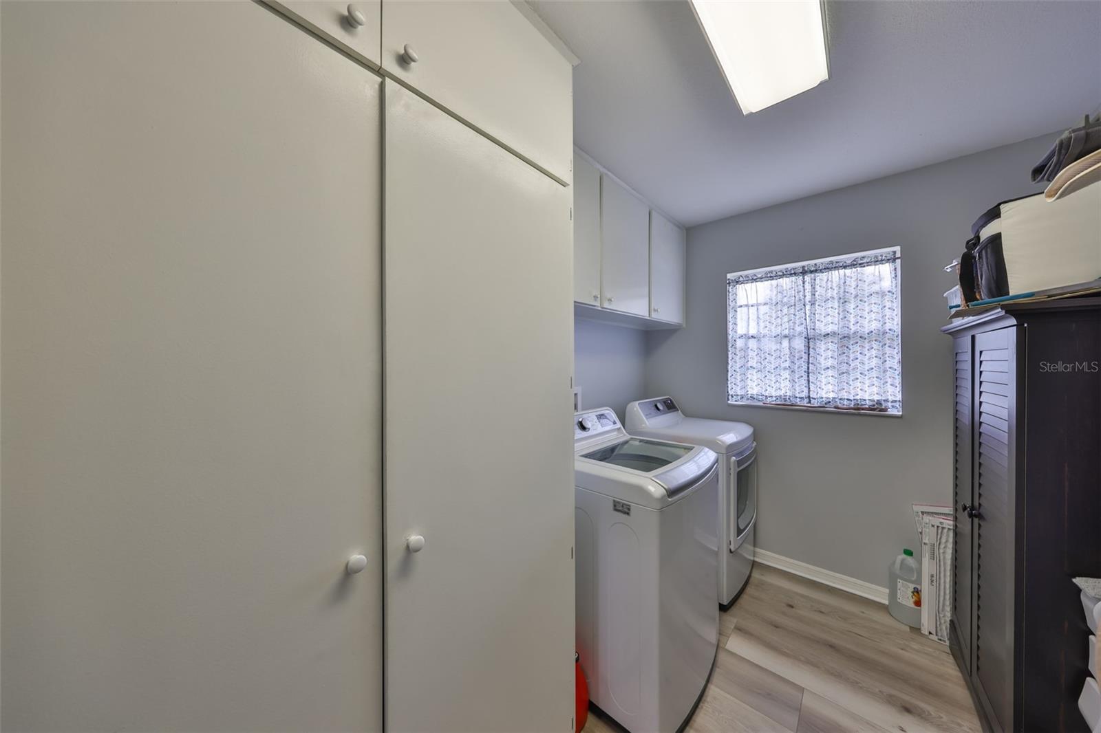 The laundry room is spacious with lots of additional storage.  Note:  The washer and dryer DO NOT CONVEY.