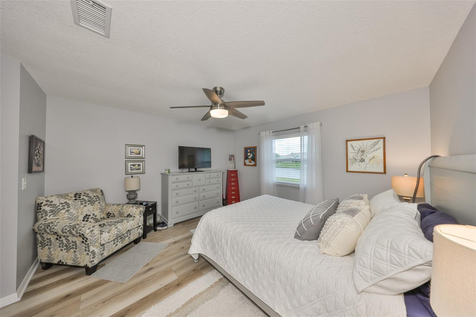 Master suite #1 is spacious and clean with a large window for natural sunshine to filter into the room.